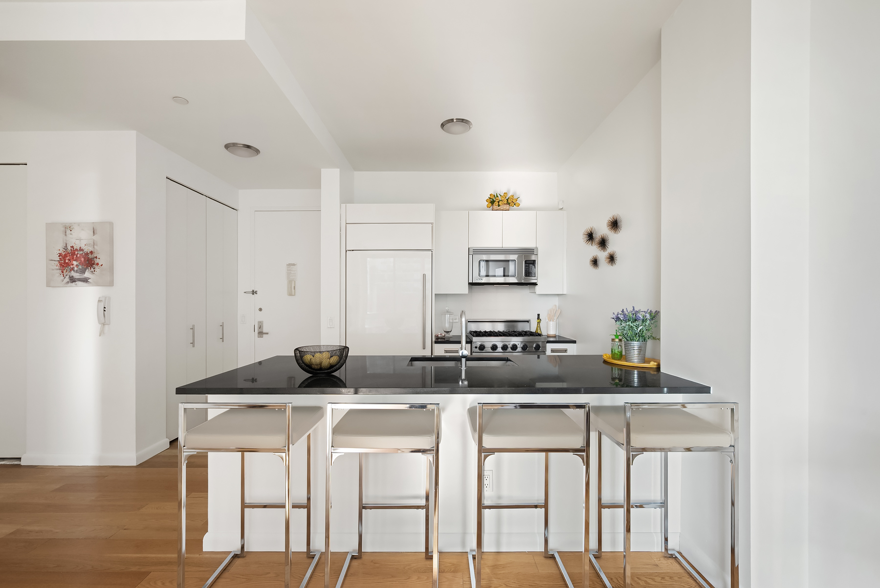 46-30 Center Boulevard, Unit 406 Queens, NY 11109 - Photo 3 of 23 a kitchen with stainless steel appliances granite countertop a sink and a refrigerator