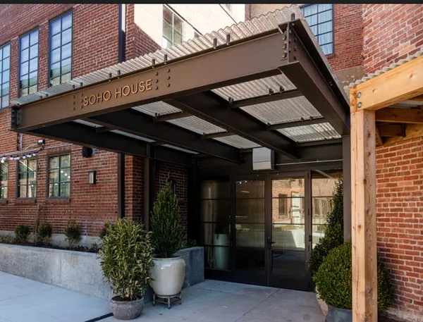 a couple of potted plants in front of a building