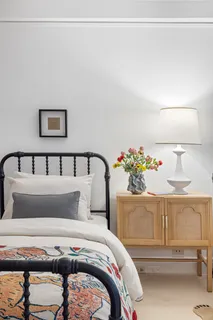 a bedroom with a bed and a dresser