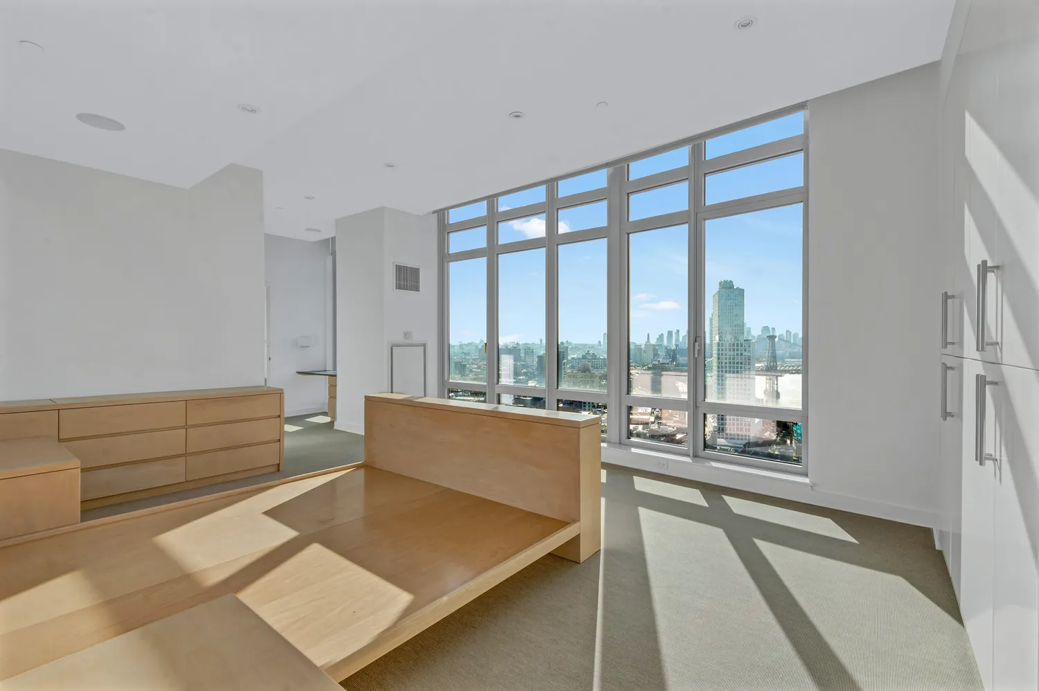 a living room with furniture and large windows