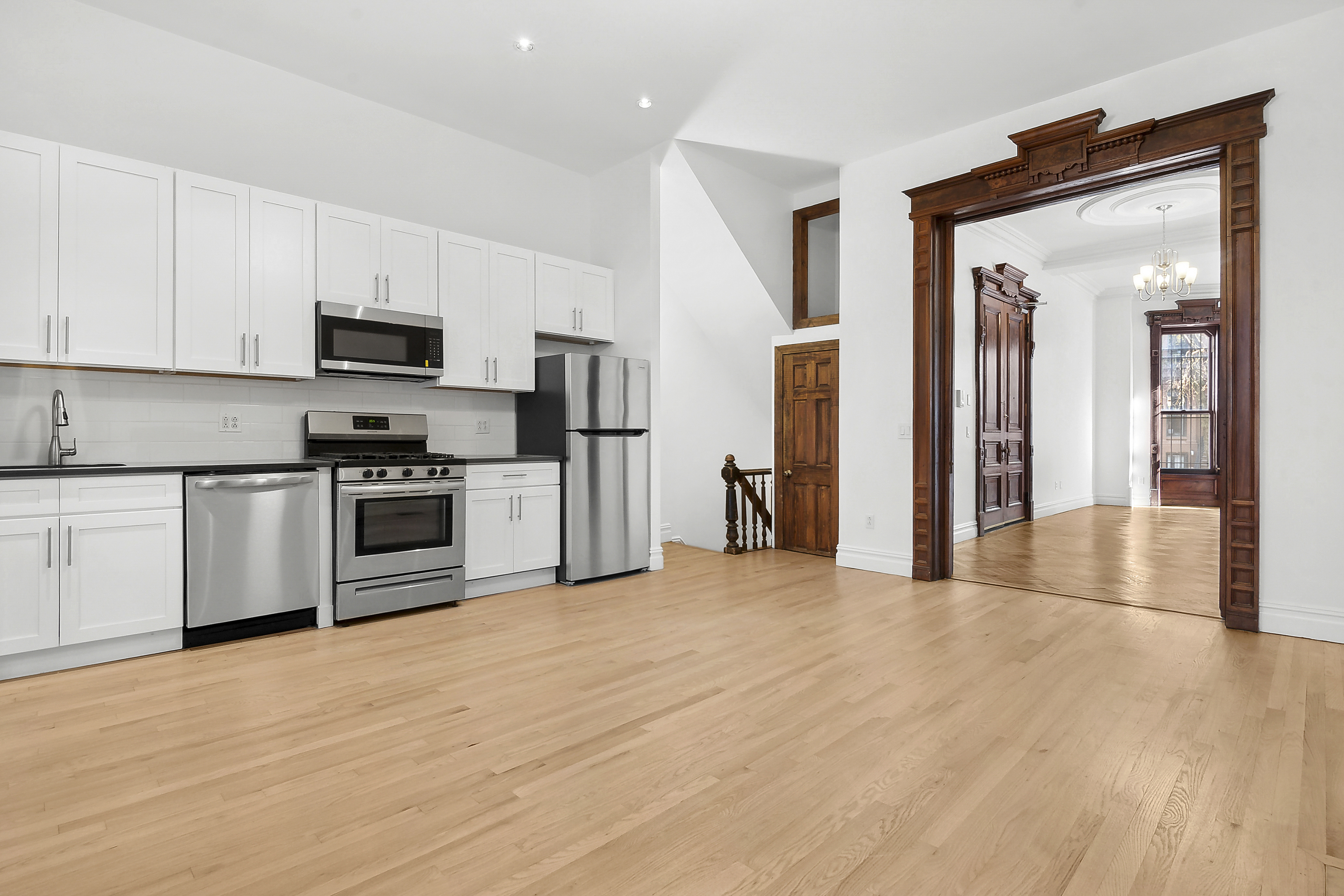 562 Washington Avenue, Unit 1 Brooklyn, NY 11238 - Photo 5 of 12 a kitchen with stainless steel appliances granite countertop a refrigerator and a stove top oven