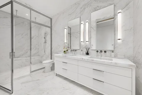 a bathroom with a double vanity sink mirror double and shower