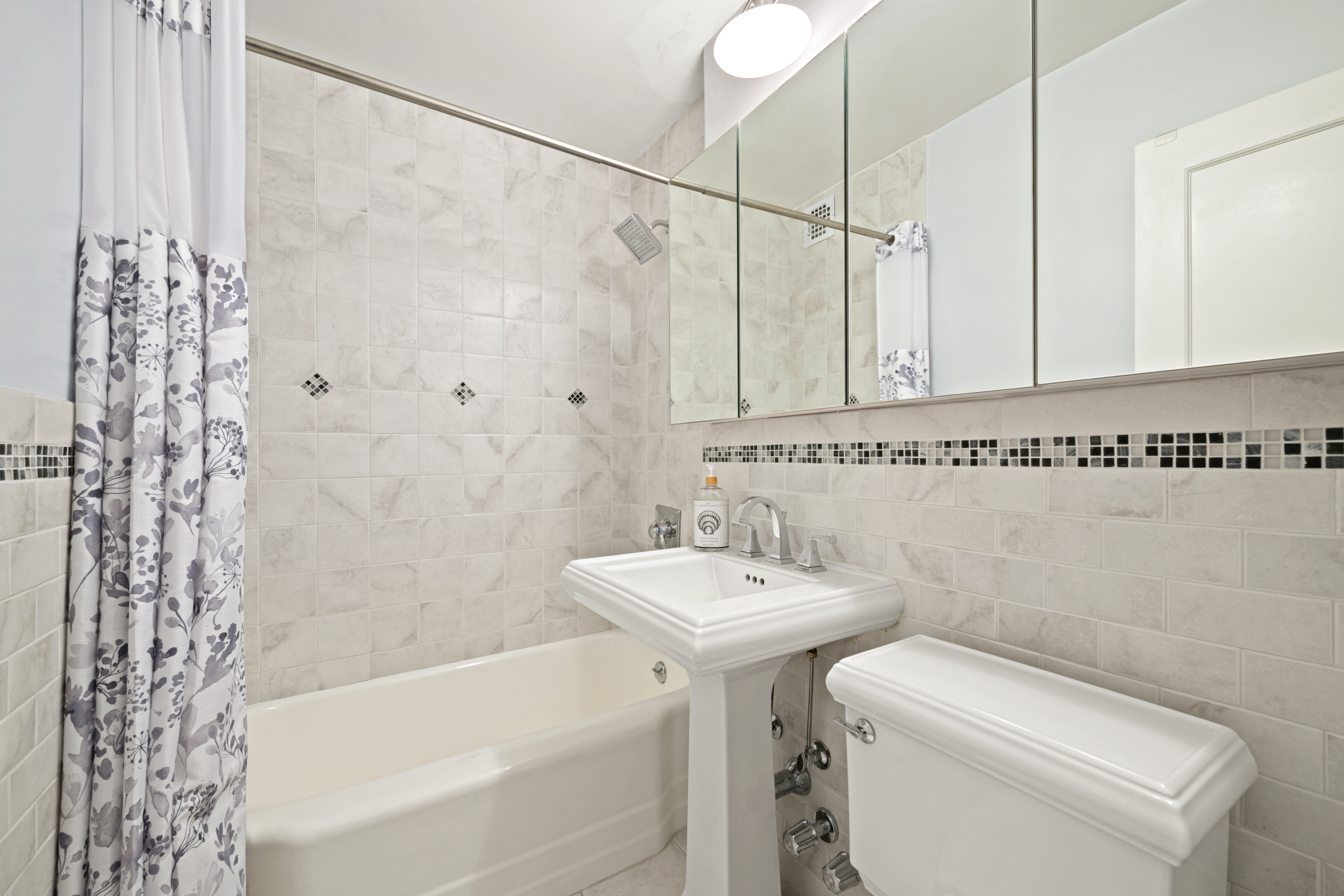 201 East 21st Street, Unit 7A Manhattan, NY 10010 - Photo 5 of 7 a bathroom with a sink a toilet and shower