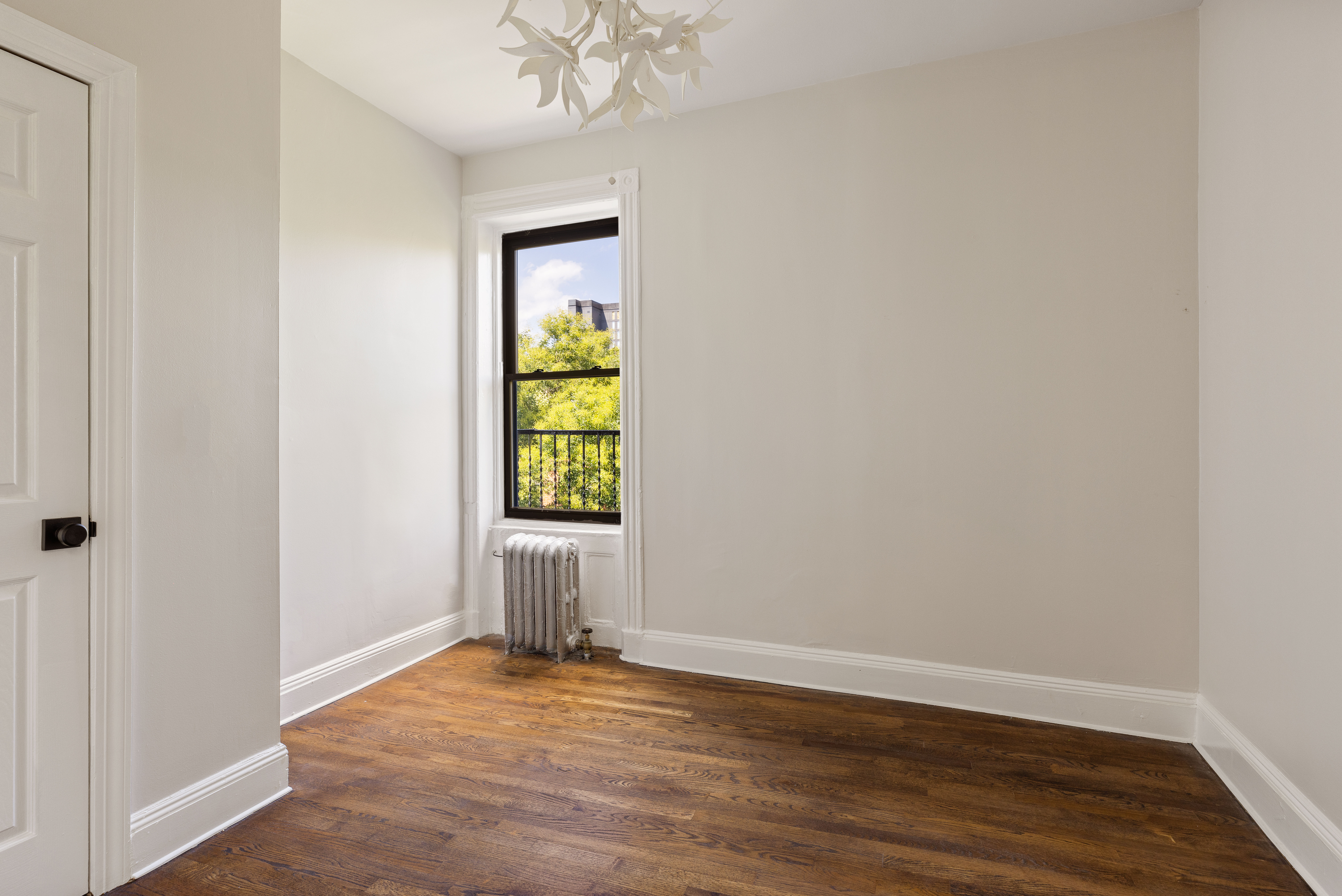208 Warren Street Brooklyn, NY 11201 - Photo 7 of 10 an empty room with wooden floor closet and mirror