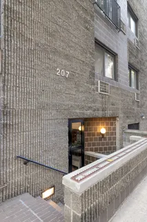 a brick building with a sink and a potted plant