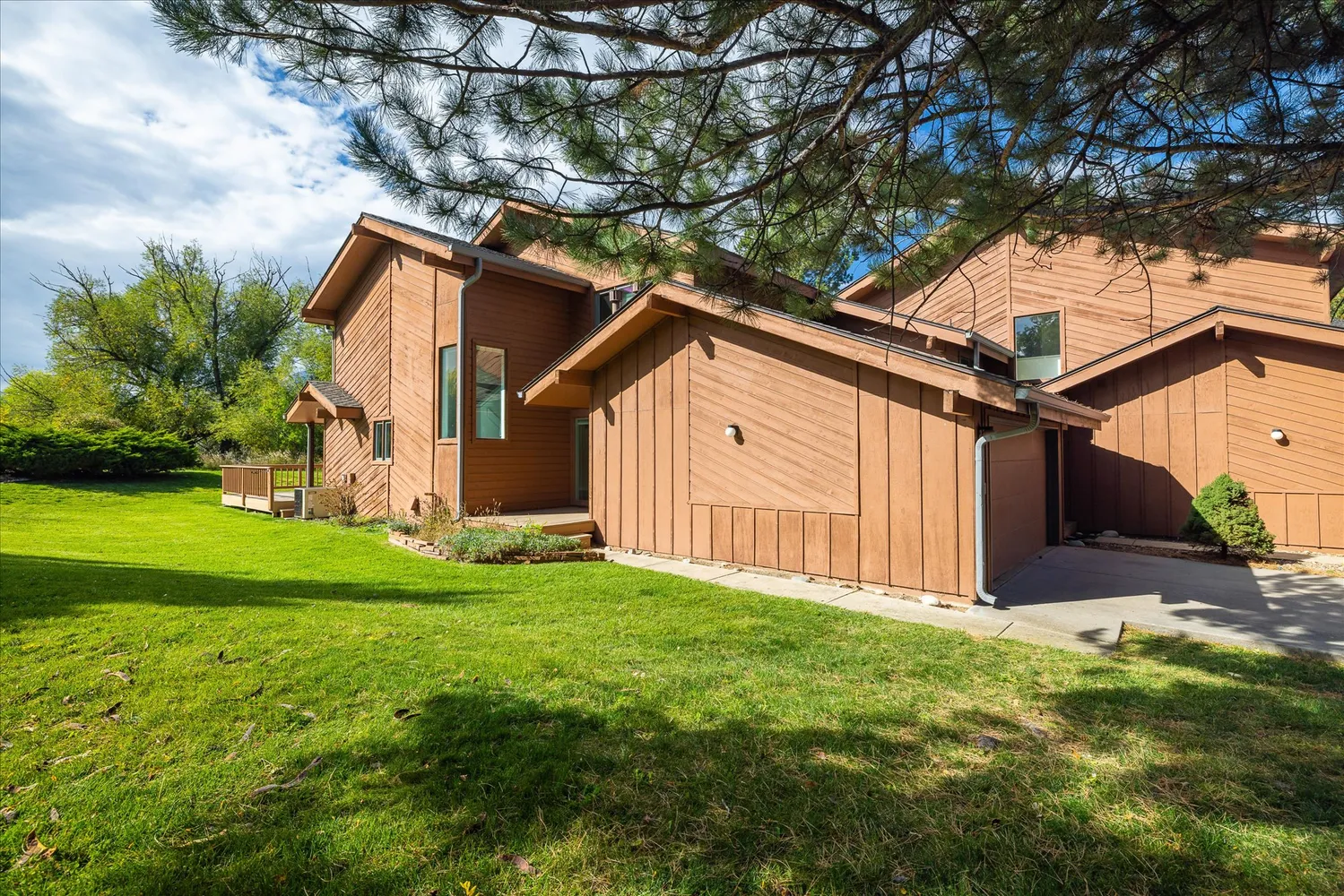 a view of backyard with garden and deck