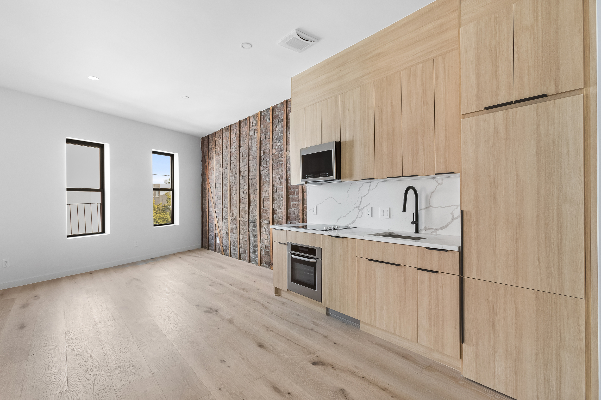 92 Jefferson Street, Unit 4 Brooklyn, NY 11206 - Photo 2 of 9 a kitchen with stainless steel appliances granite countertop a refrigerator a stove and a sink with wooden floors