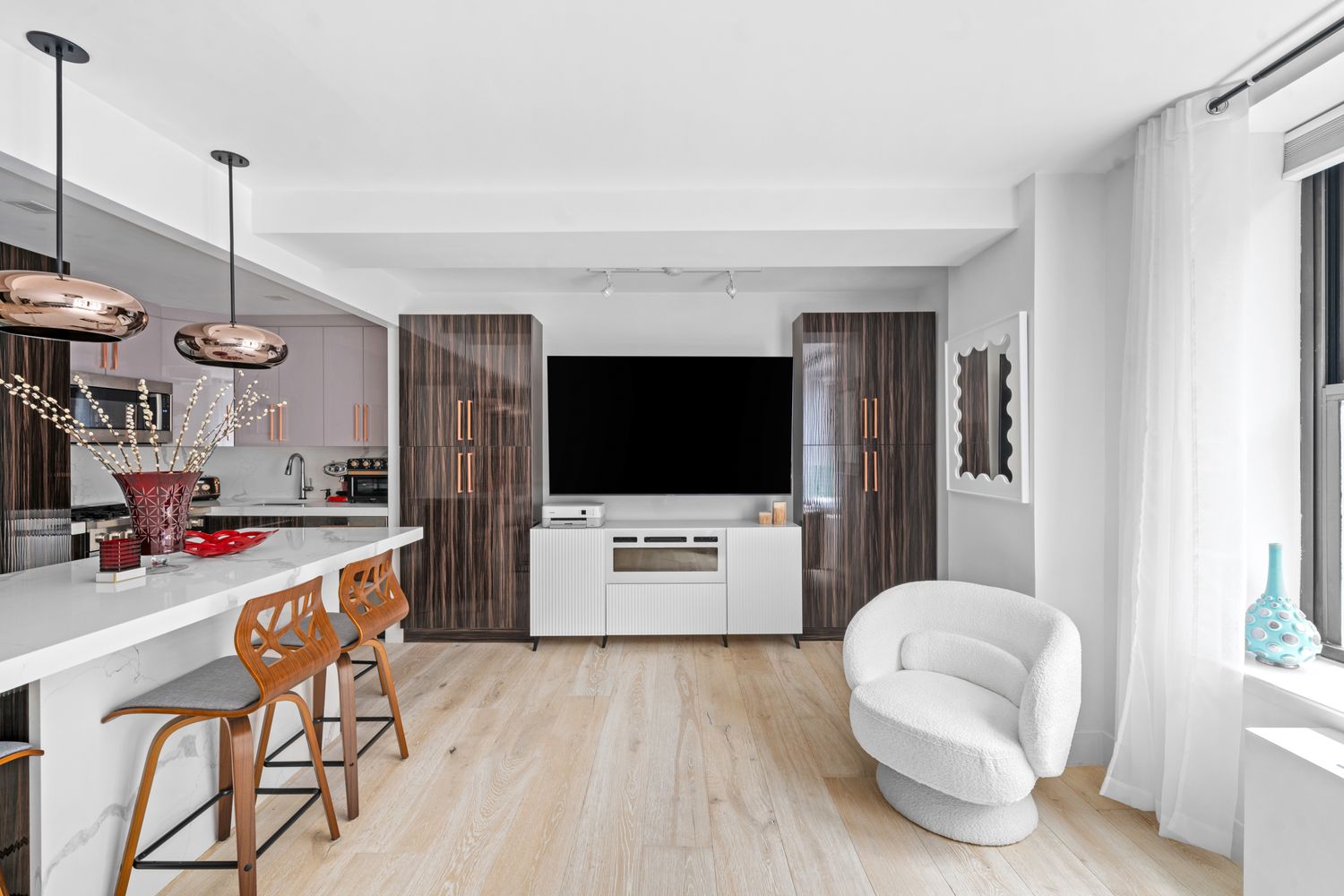 201 West 74th Street, Unit 8G Manhattan, NY 10023 - Photo 5 of 14 a living room with furniture and a flat screen tv