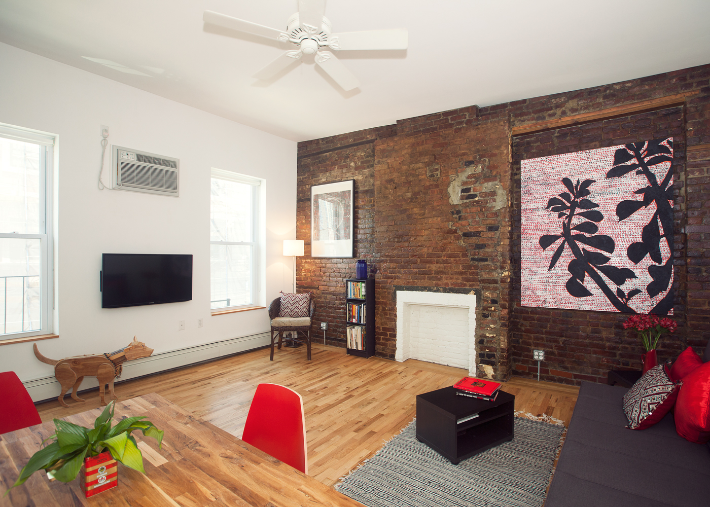 5-46 50th Avenue Queens, NY 11101 - Photo 6 of 17 a living room with furniture and a flat screen tv