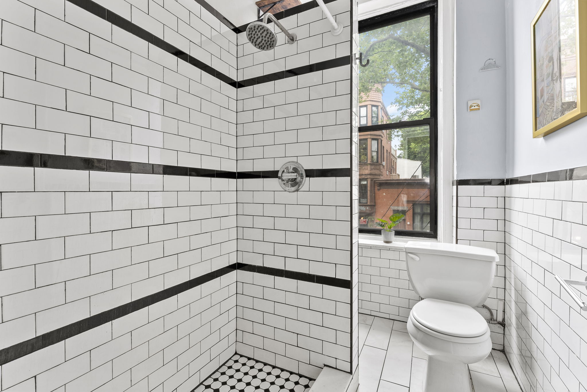 311 Henry Street, Unit 1 Brooklyn, NY 11201 - Photo 4 of 7 a bathroom with a sink toilet and shower