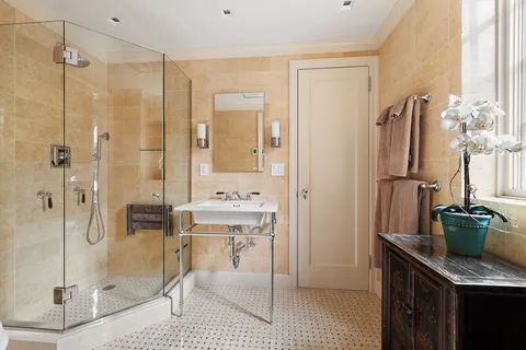 a bathroom with a granite countertop sink a toilet and shower