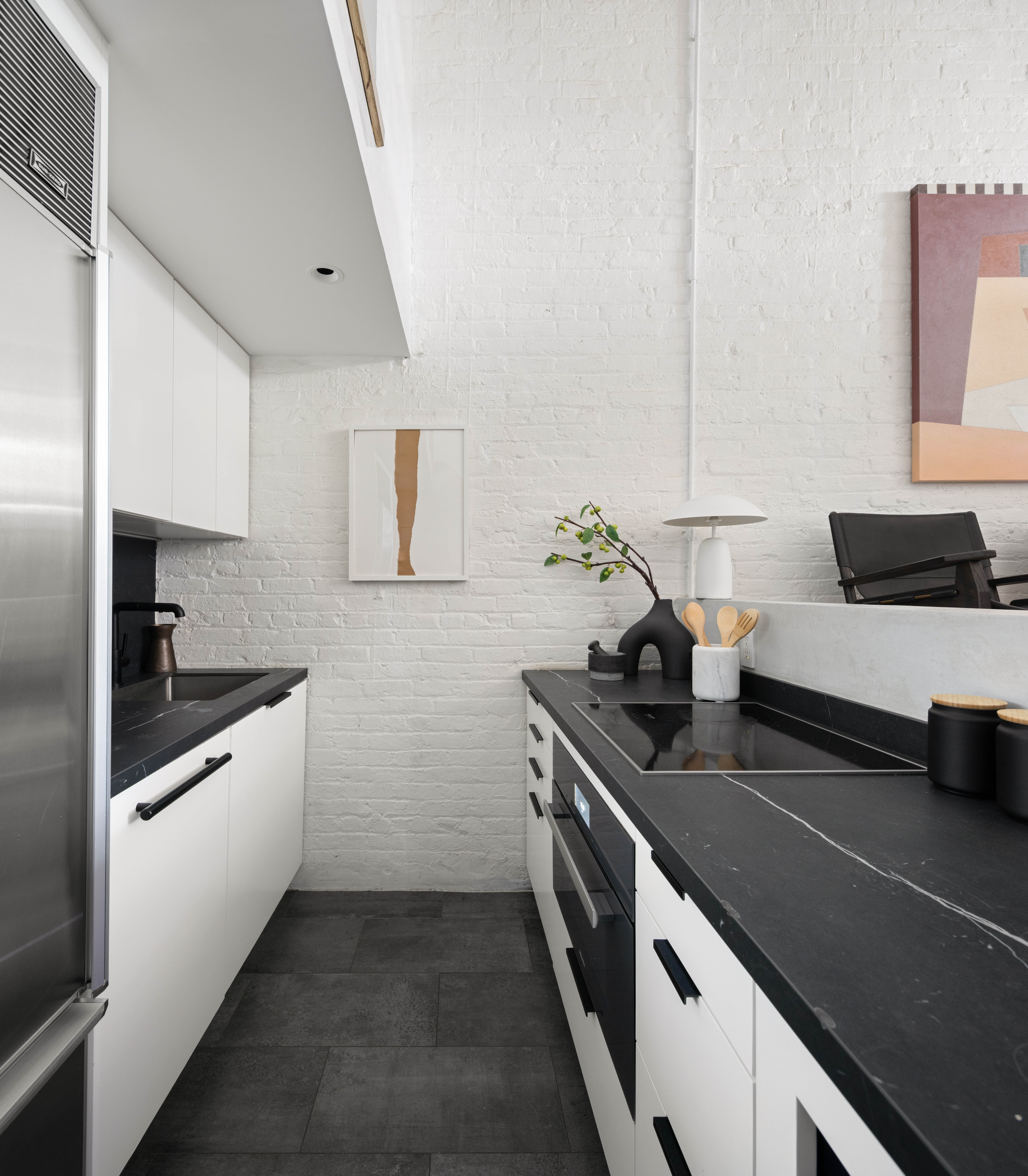 165 Perry Street, Unit 1D Manhattan, NY 10014 - Photo 7 of 13 a kitchen with stainless steel appliances a sink stove and cabinets