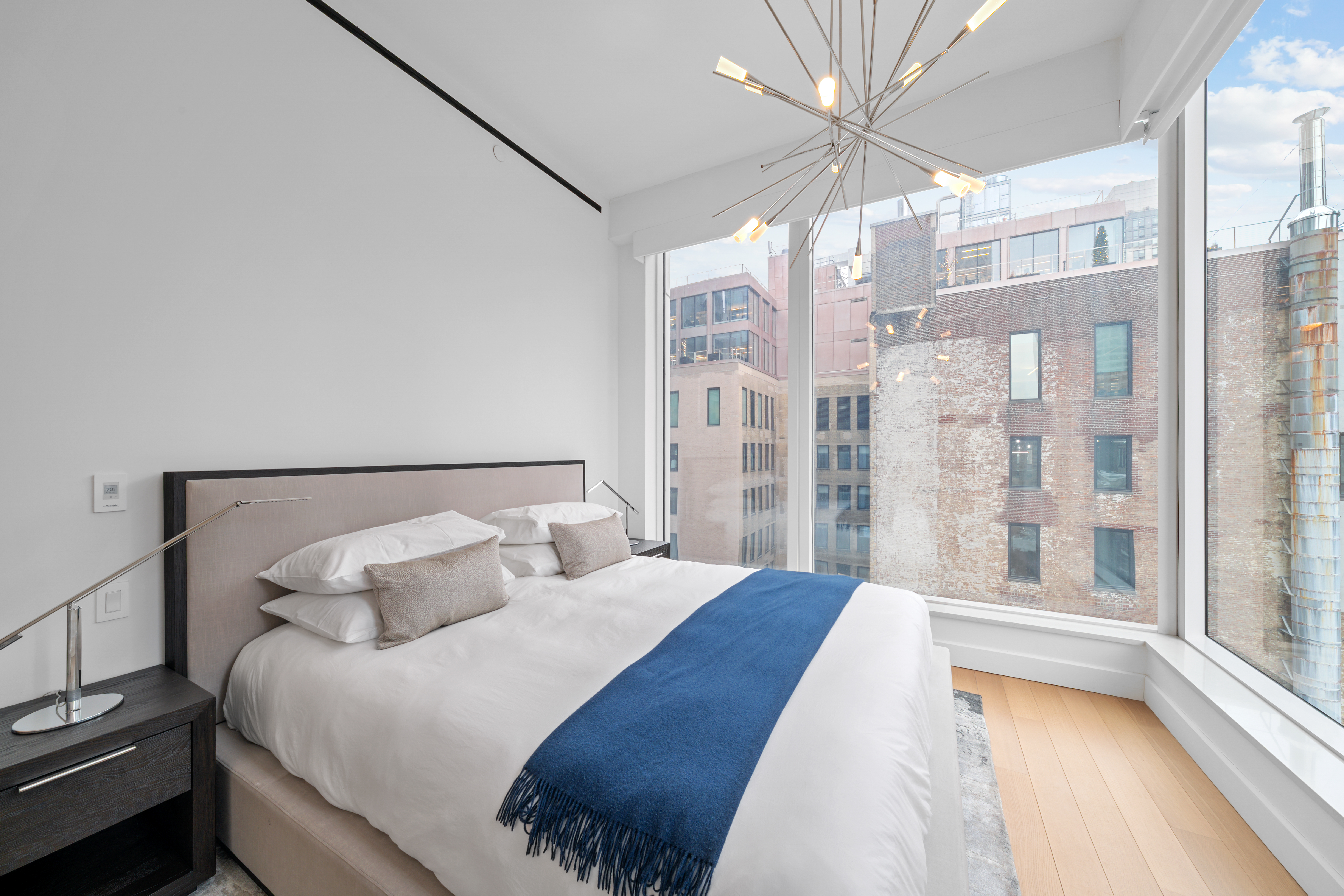 15 East 30th Street, Unit 19B Manhattan, NY 10016 - Photo 18 of 40 a spacious bedroom with a bed and a large window