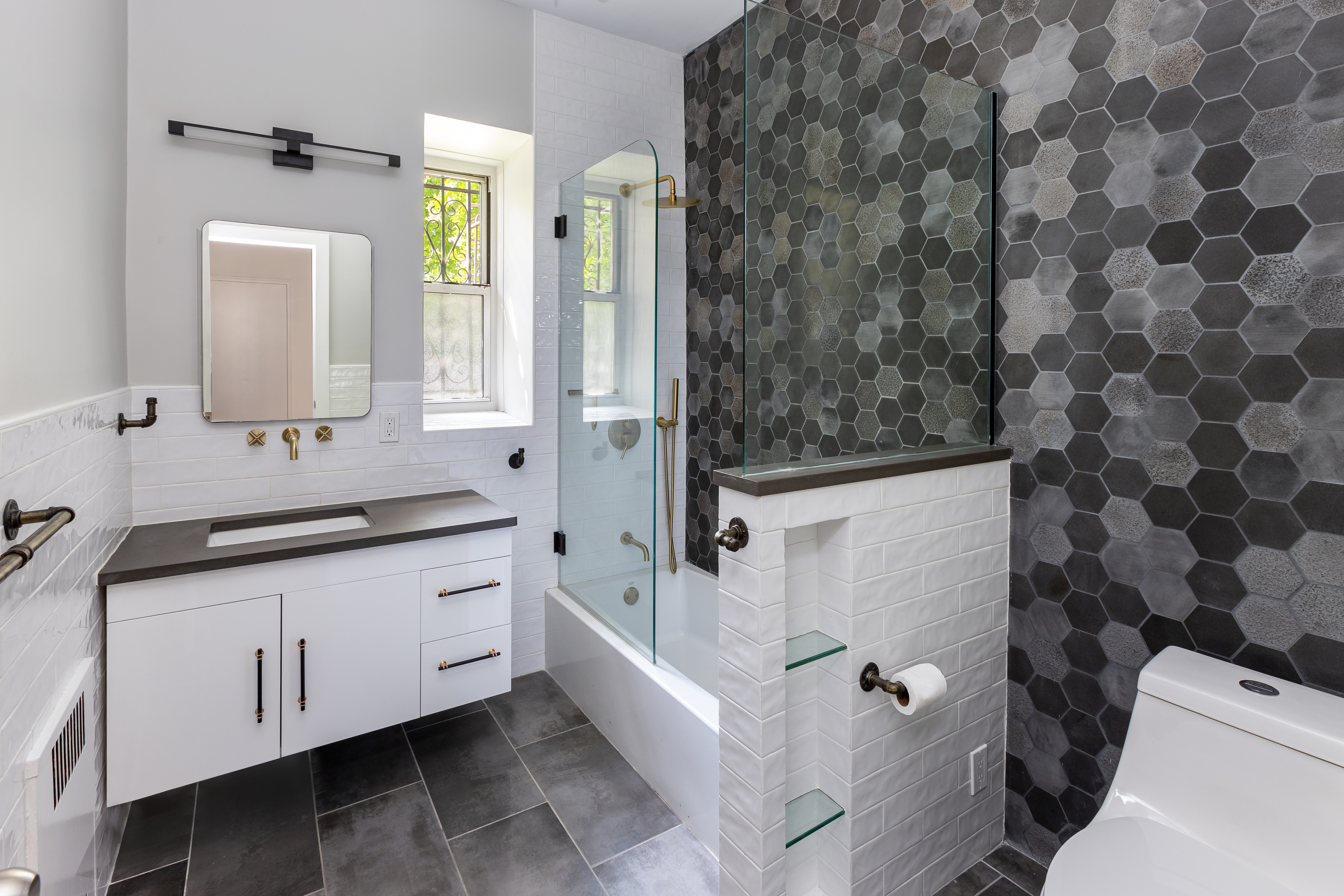 60 Plaza Street East, Unit 1G Brooklyn, NY 11238 - Photo 4 of 13 a bathroom with a granite countertop sink a toilet and shower