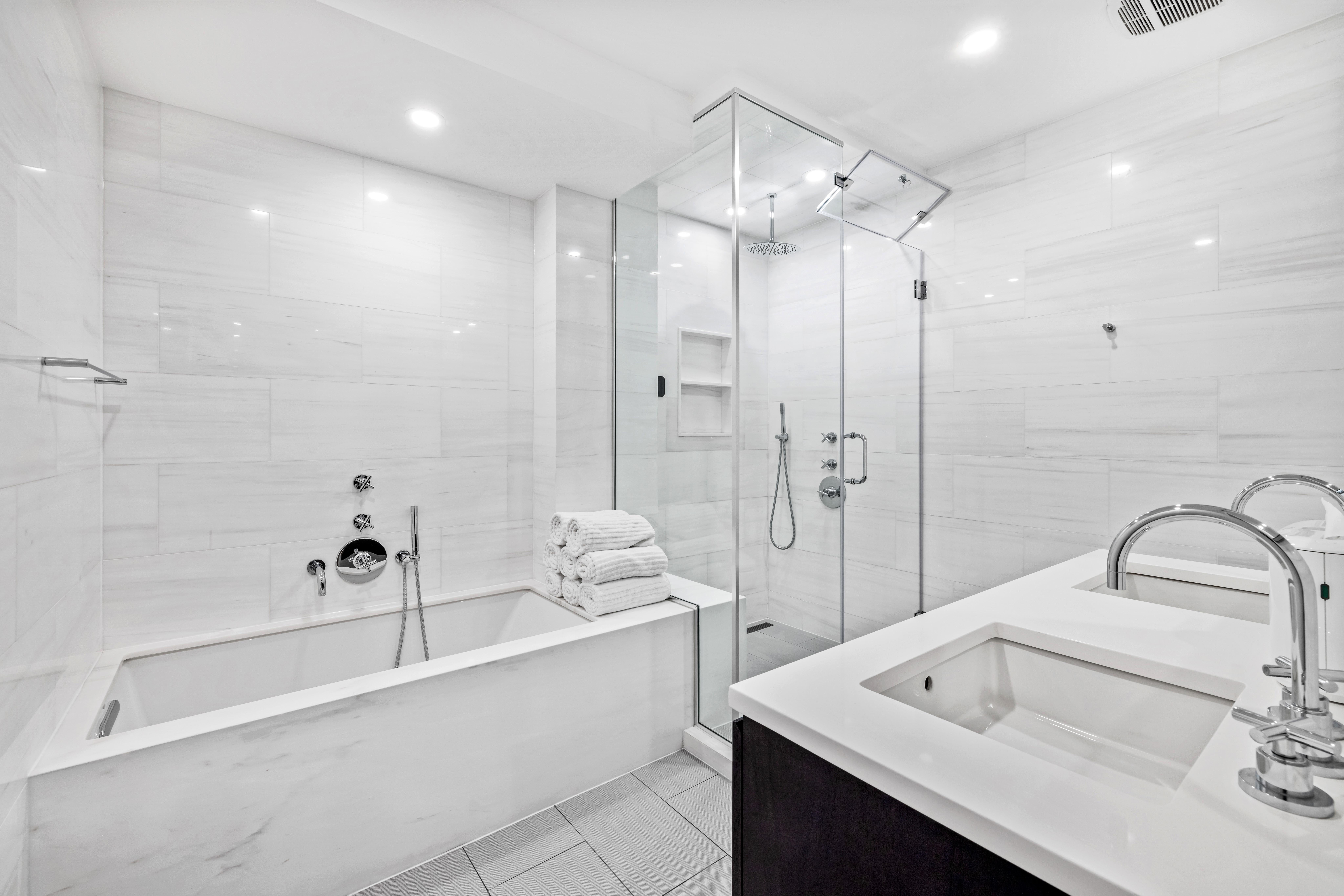 17 East 17th Street, Unit 4 Manhattan, NY 10003 - Photo 9 of 11 a bathroom with a tub sink shower and mirror