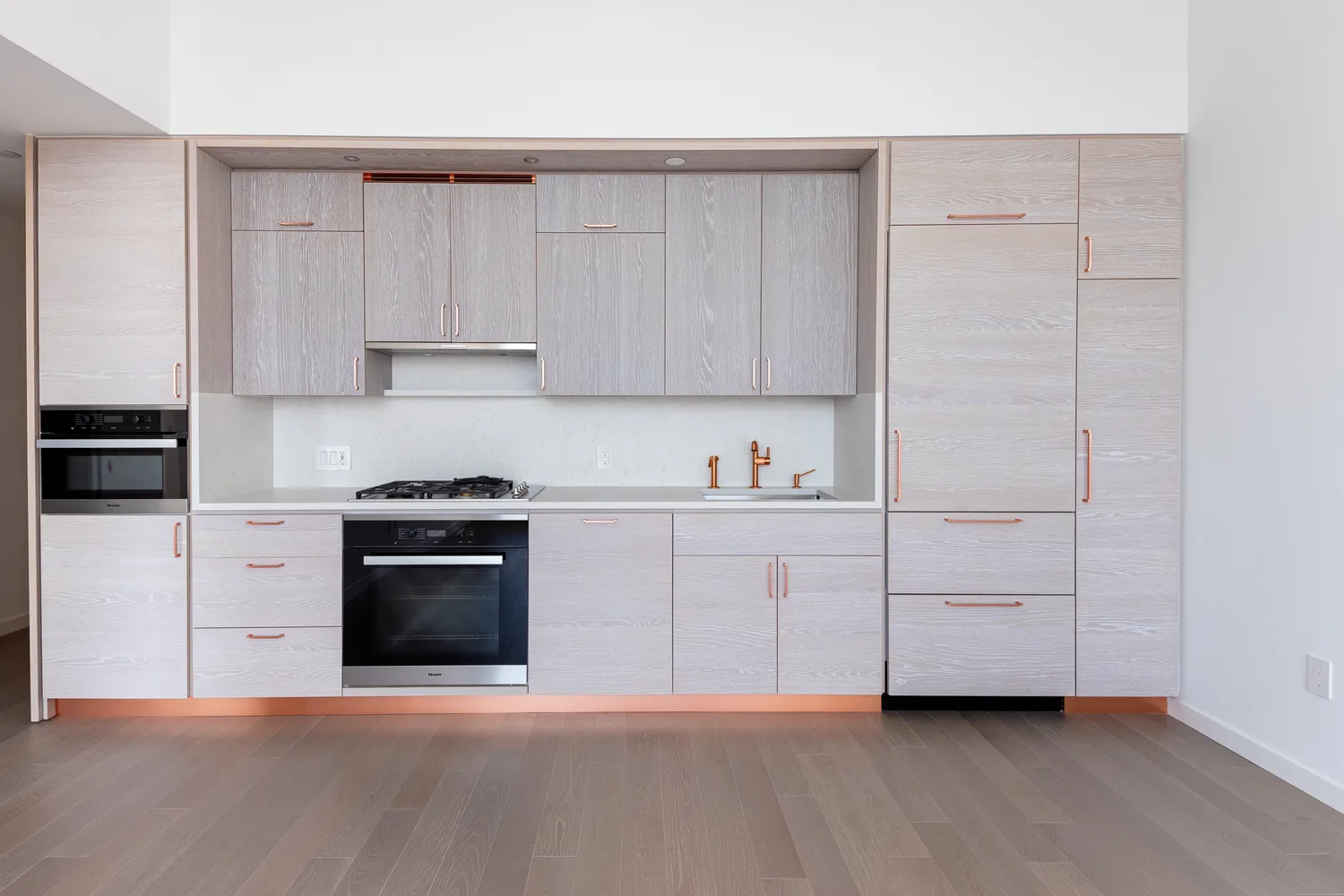 a kitchen with cabinets stainless steel appliances and a window