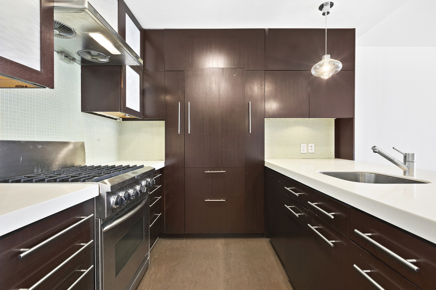 5 East 22nd Street, Unit 28M Manhattan, NY 10010 - Photo 5 of 11 a kitchen with a sink and stove top oven