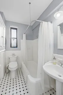 a bathroom with a sink toilet a mirror and shower