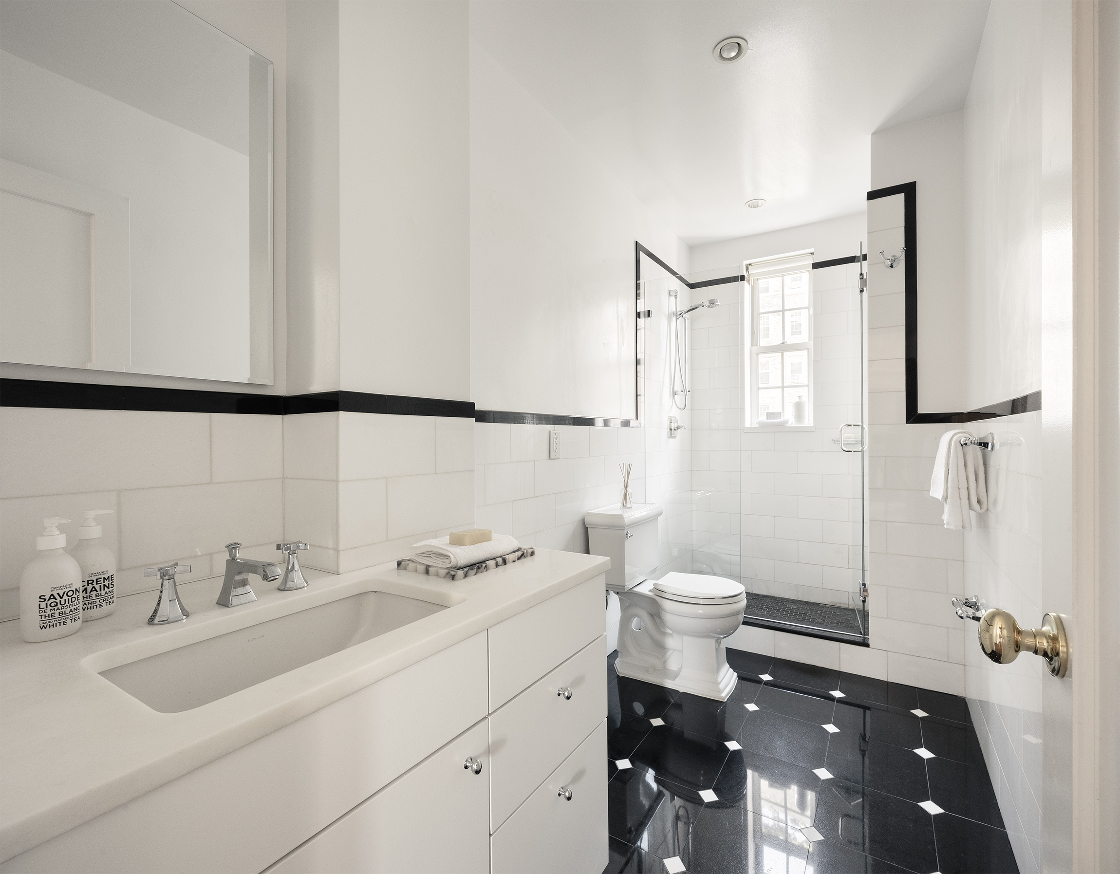 25 5th Avenue, Unit 8F Manhattan, NY 10003 - Photo 6 of 7 a bathroom with a sink toilet and shower