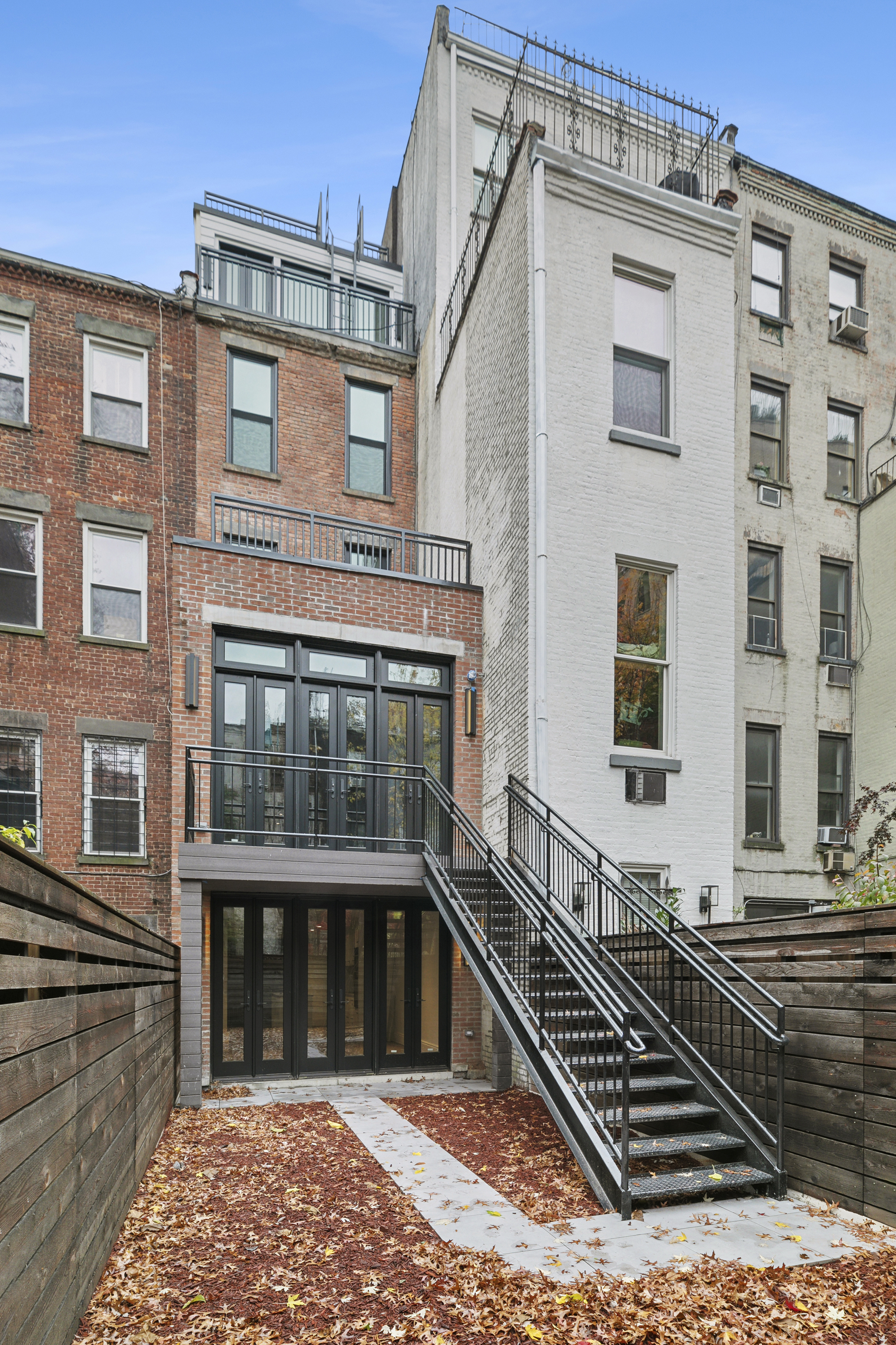 47 West 94th Street Manhattan, NY 10025 - Photo 11 of 20 a front view of a house with a yard