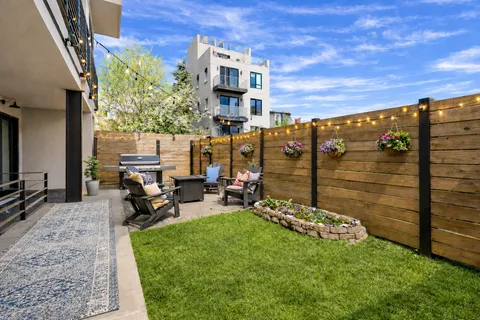 a view of a chairs and table in backyard