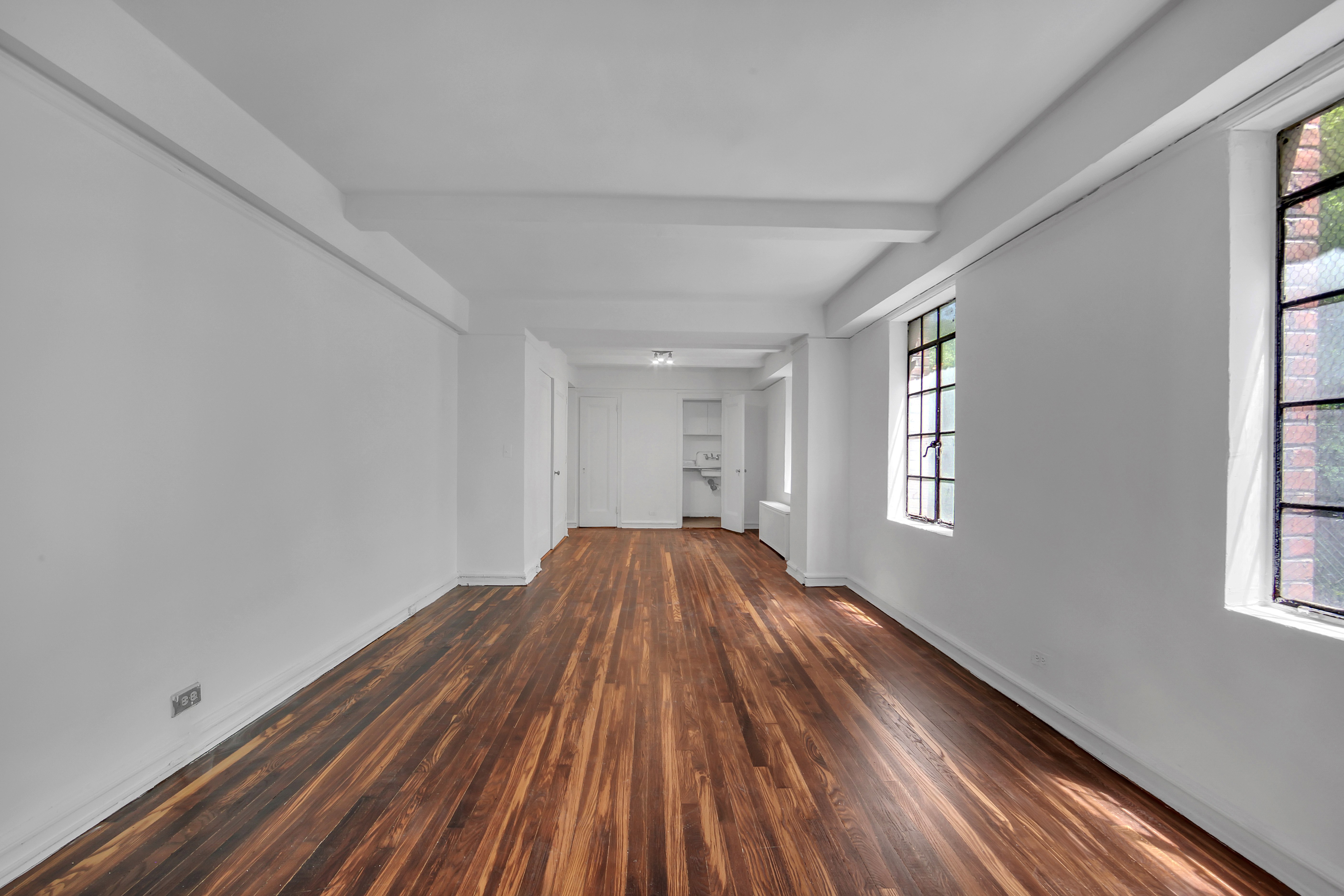 320 East 42nd Street, Unit 418 Manhattan, NY 10017 - Photo 5 of 10 a view of a room with wooden floor and windows
