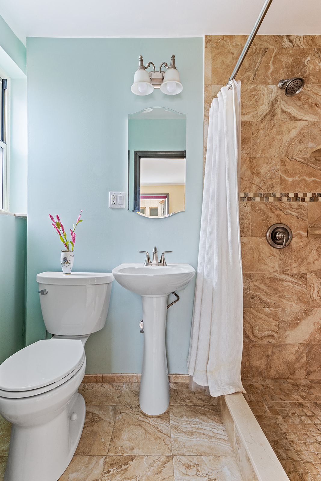 9281 Shore Road, Unit 207 Brooklyn, NY 11209 - Photo 7 of 11 a bathroom with a sink toilet and shower