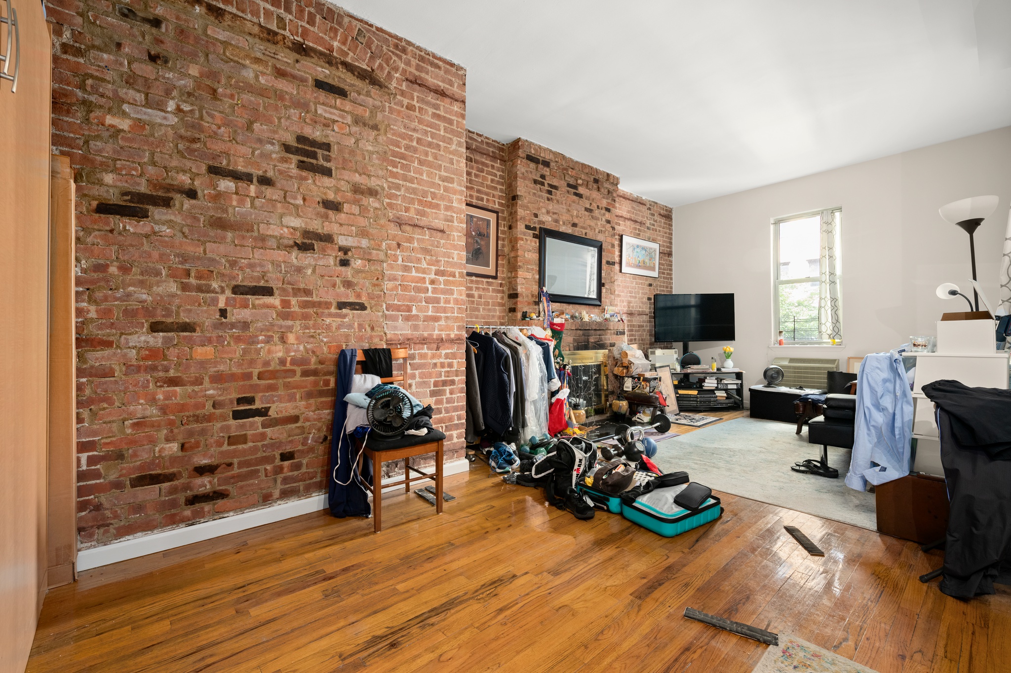 305 West 55th Street, Unit 2B Manhattan, NY 10019 - Photo 8 of 9 a view of a livingroom with furniture and a fireplace