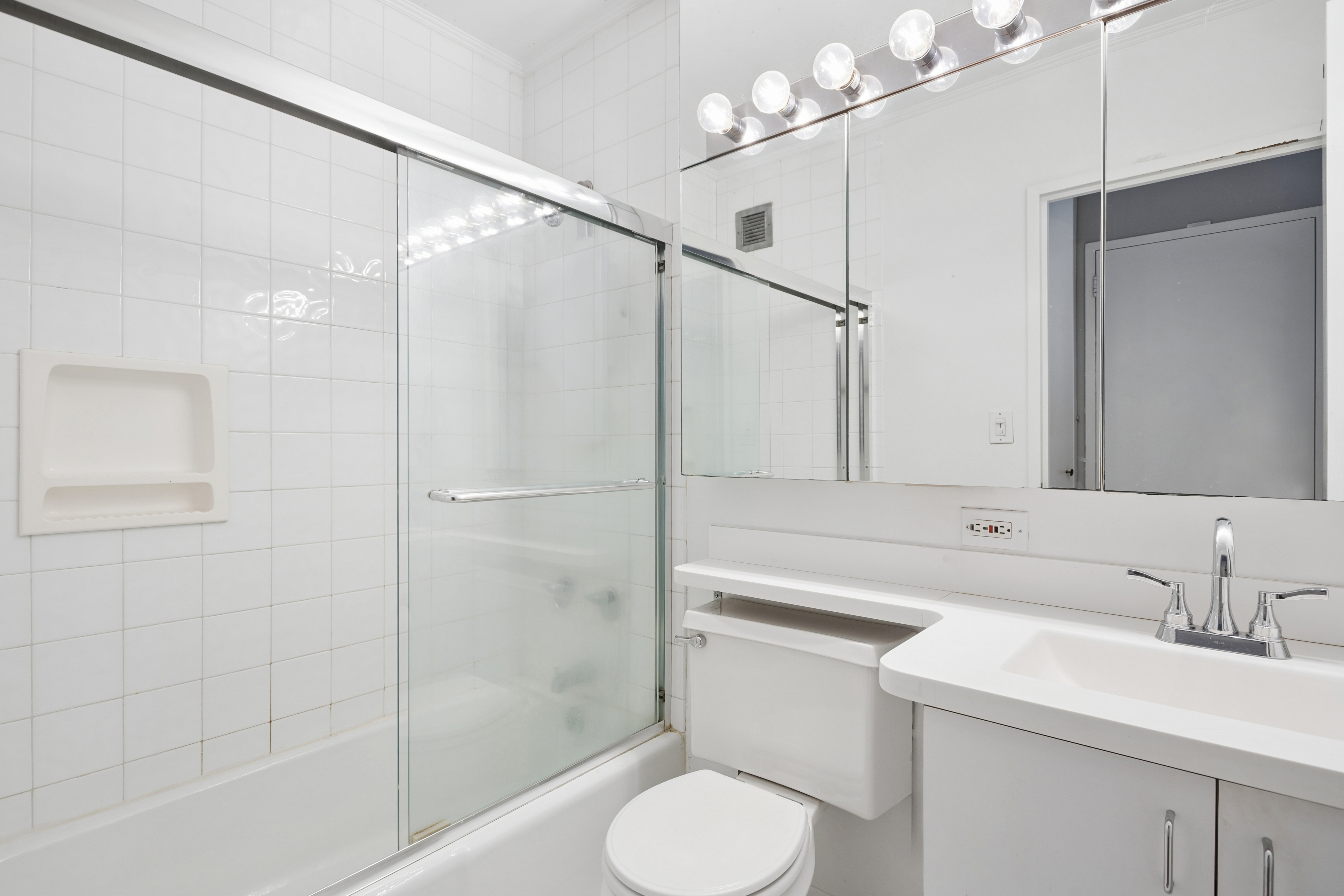 300 East 54th Street, Unit 29H Manhattan, NY 10022 - Photo 8 of 14 a bathroom with a sink toilet and shower