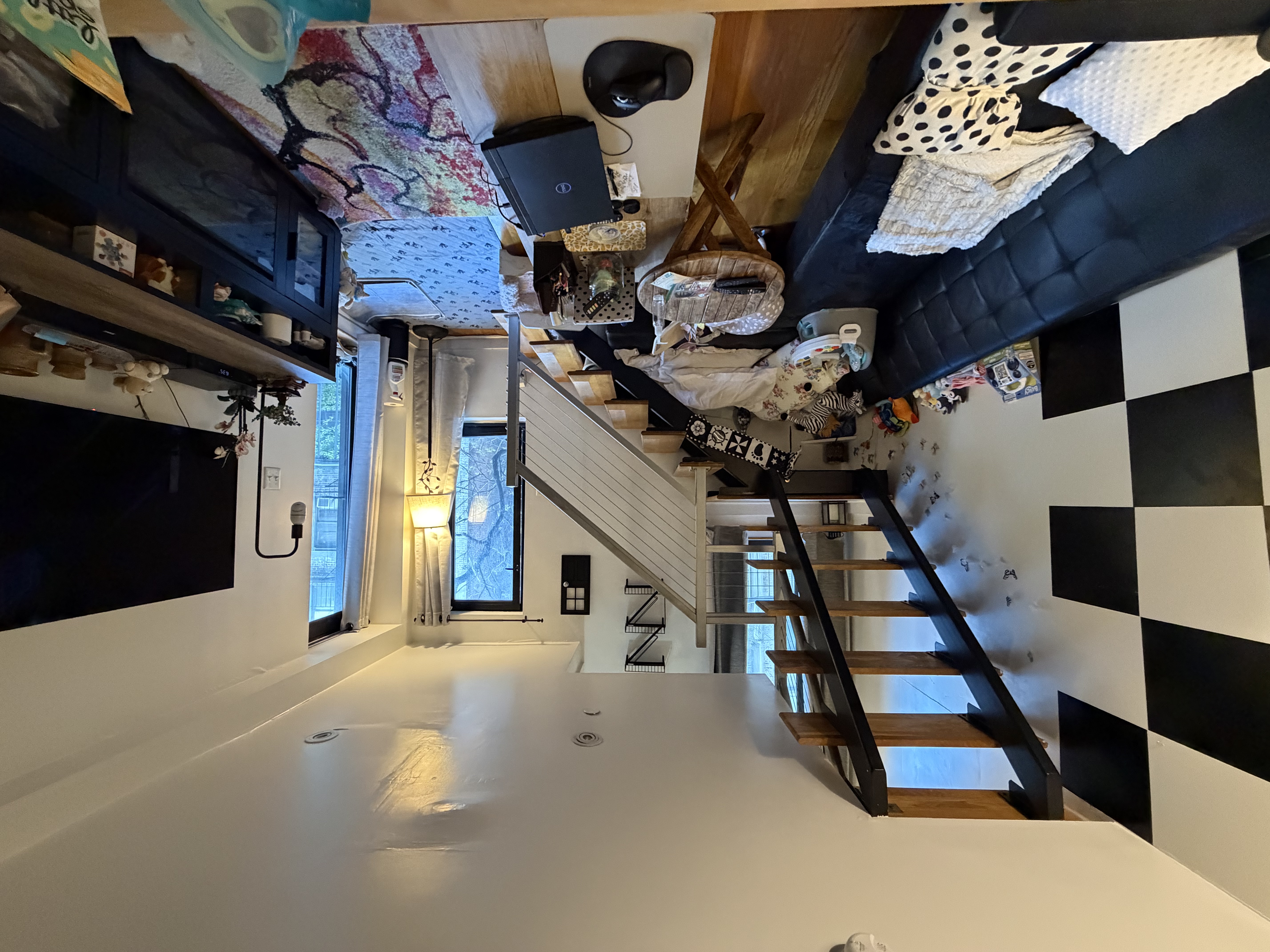 215 East 81st Street, Unit 5E Manhattan, NY 10028 - Photo 2 of 7 a living room with furniture and a flat screen tv