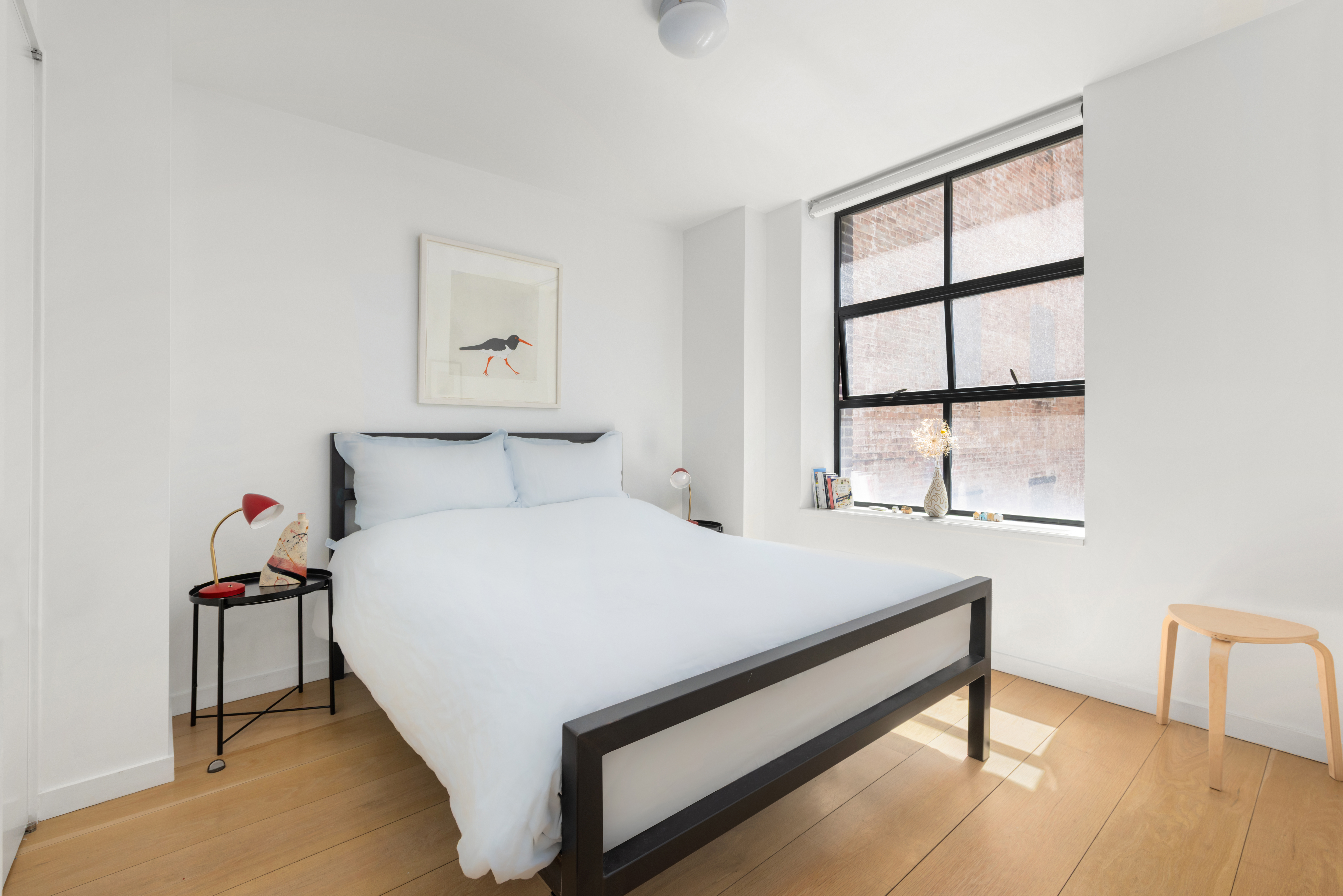 456 West 19th Street, Unit 4/5A Manhattan, NY 10011 - Photo 10 of 15 a bed sitting in a bedroom next to a window