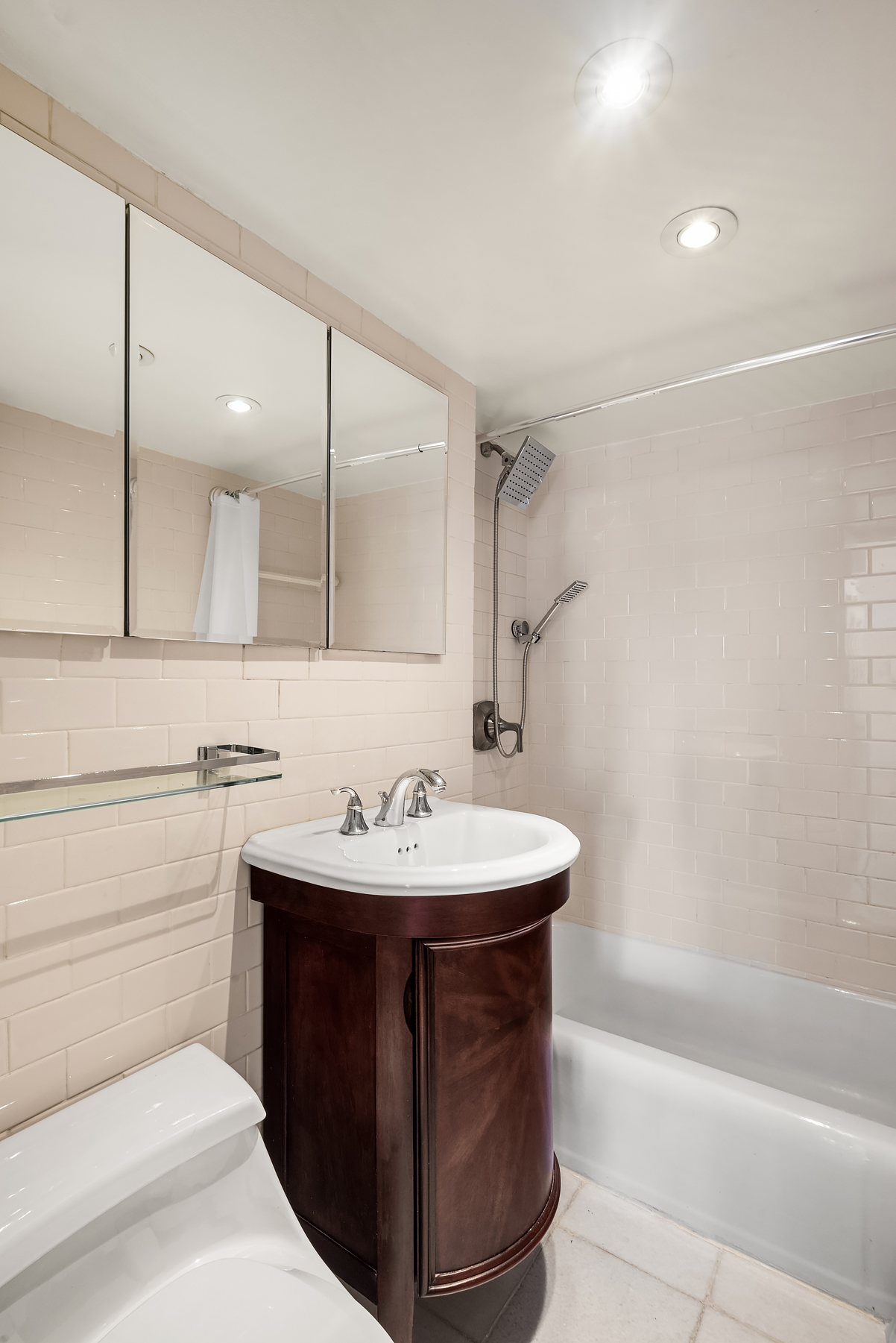 220 East 57th Street, Unit 17J Manhattan, NY 10022 - Photo 2 of 5 a bathroom with a sink a toilet and a bathtub