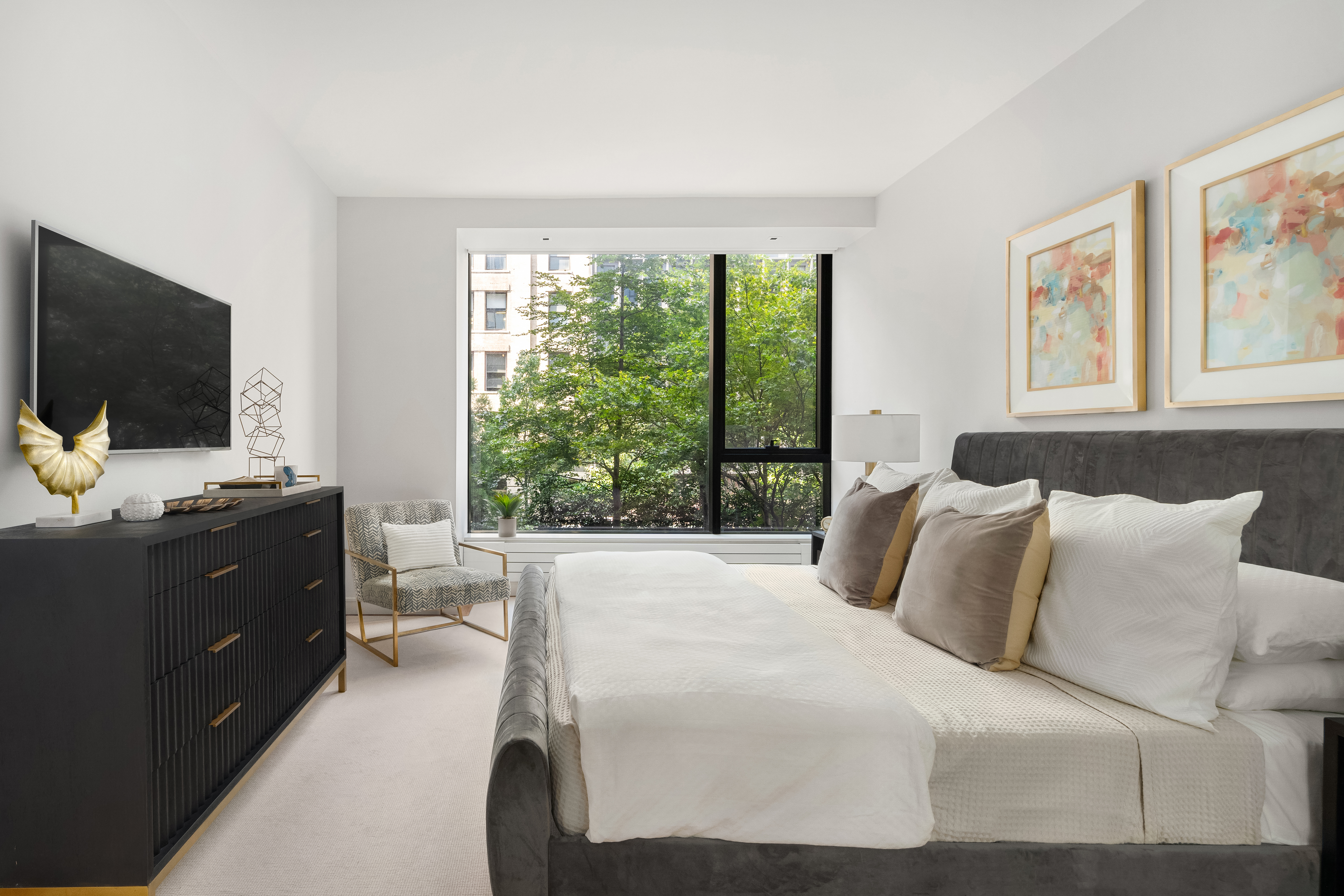 255 Hudson Street, Unit TH1 Manhattan, NY 10013 - Photo 6 of 9 a bedroom with a bed and a flat screen tv