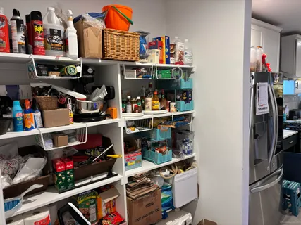 a room with lots of books and a dining table