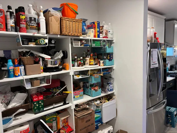 a room with lots of books and a dining table