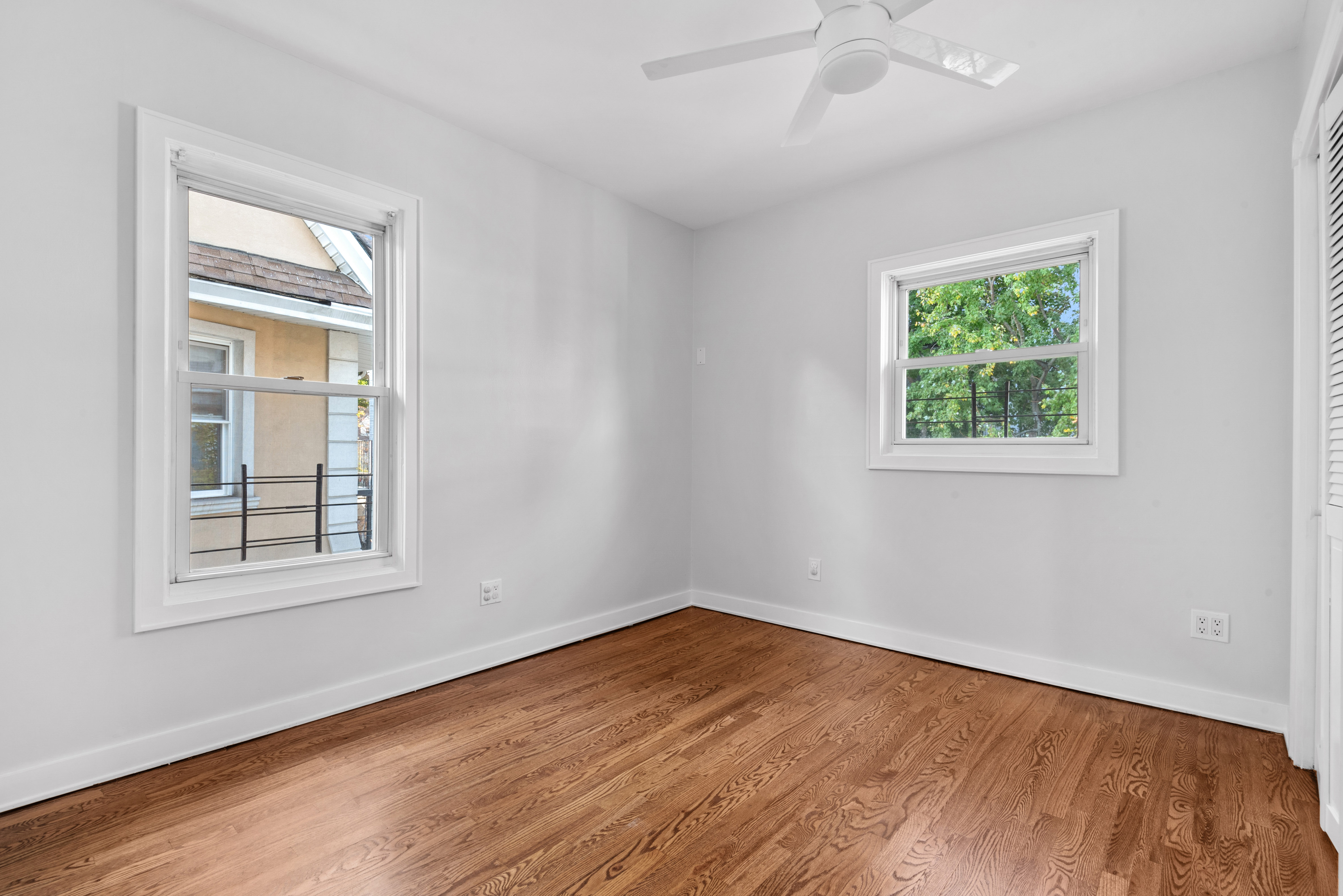 1617 Dorchester Road, Unit 2 Brooklyn, NY 11226 - Photo 6 of 6 an empty room with wooden floor and windows