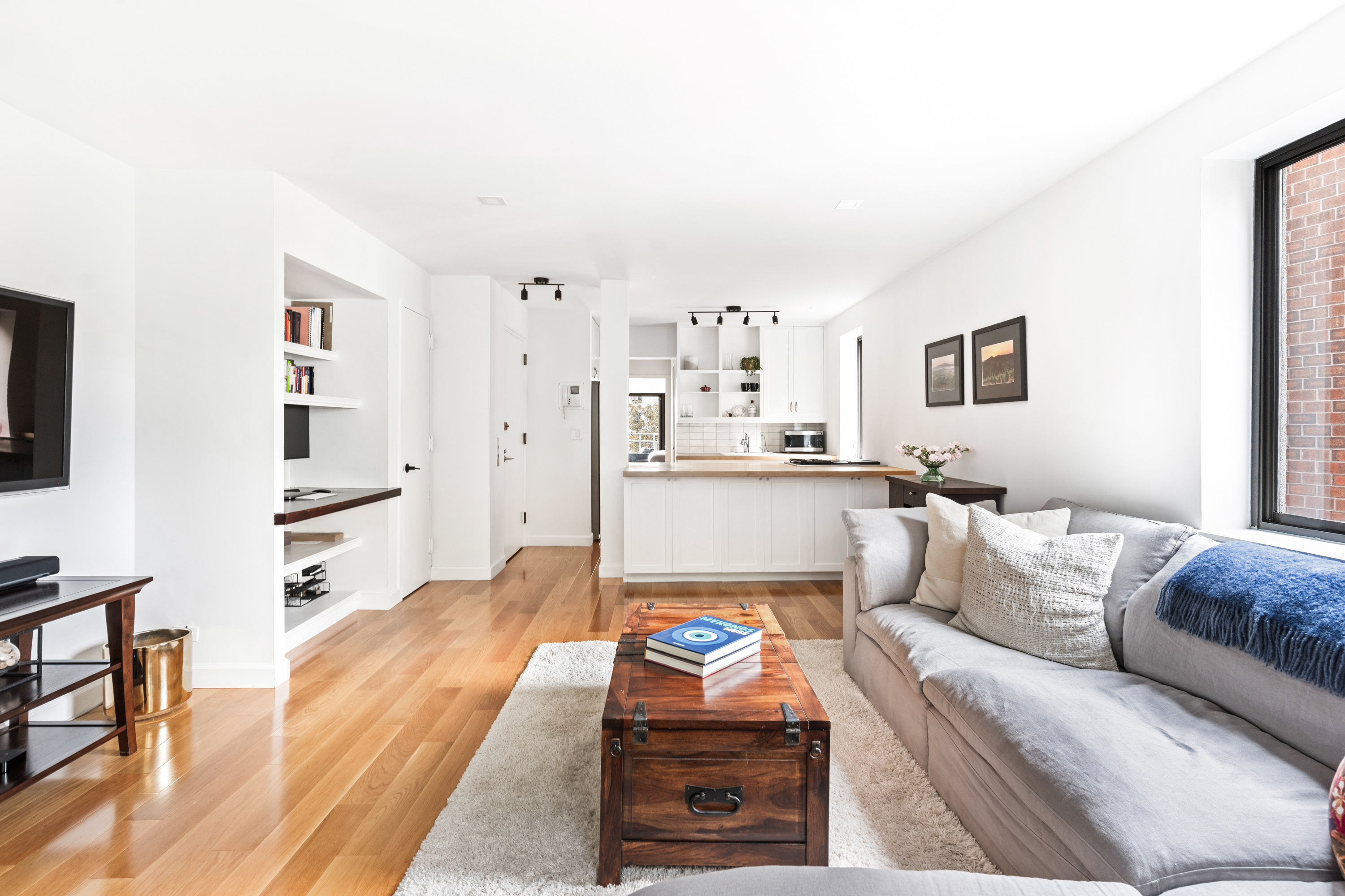 164 Bank Street, Unit 5B Manhattan, NY 10014 - Photo 2 of 11 a living room with furniture and a flat screen tv