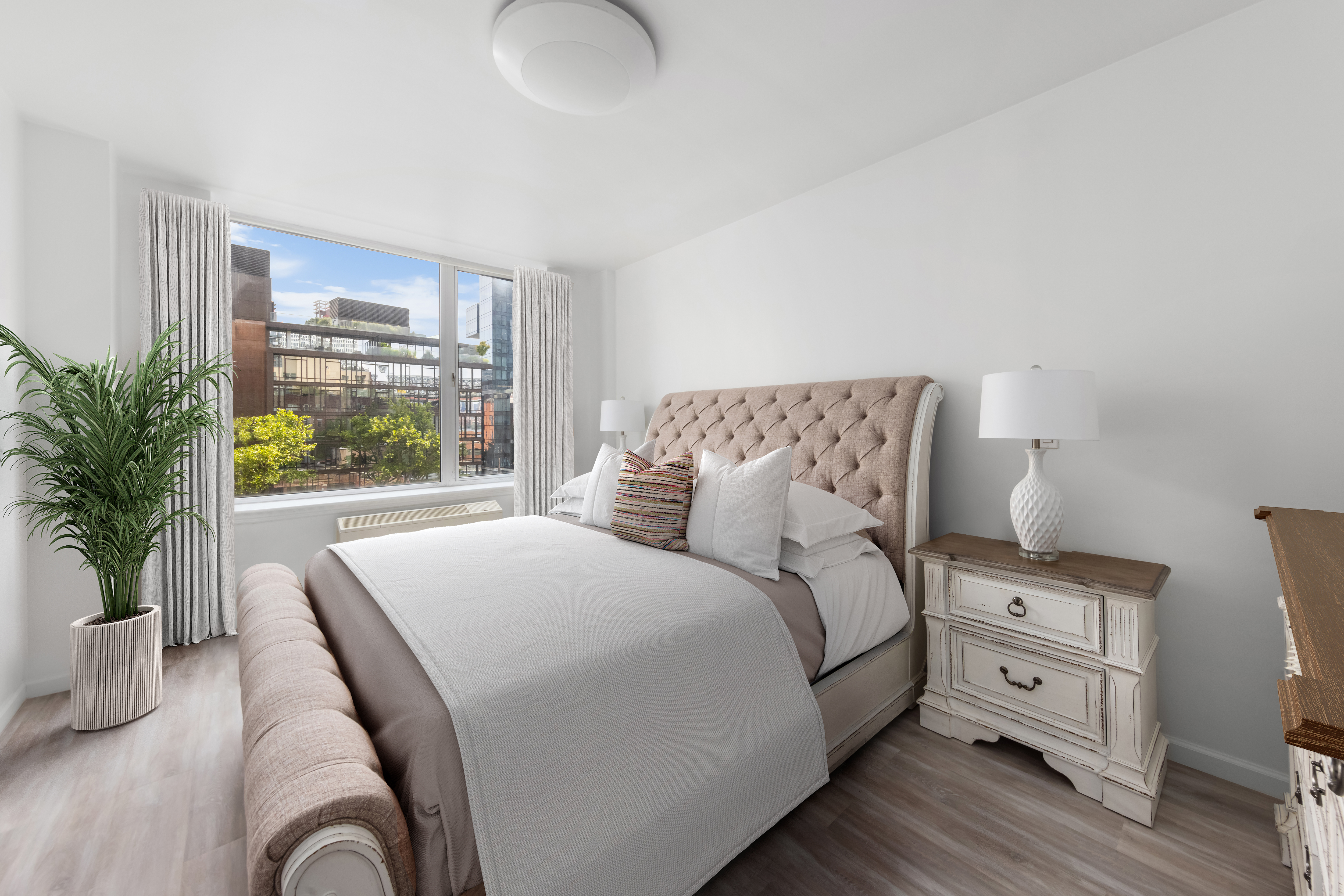 26 Broadway, Unit 402 Brooklyn, NY 11249 - Photo 6 of 17 a bedroom with a bed and a large window