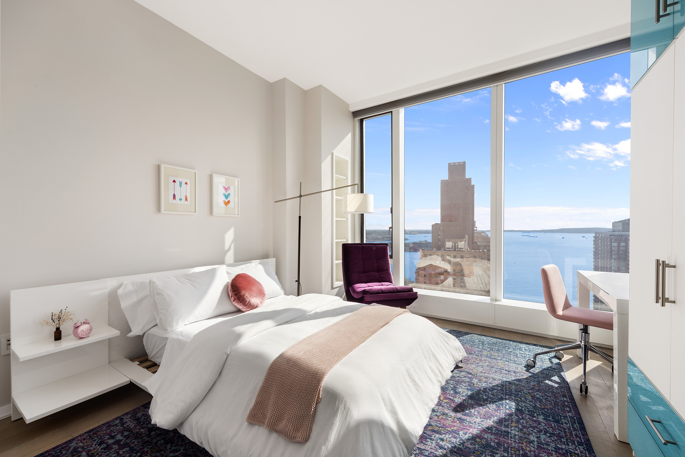 50 West Street, Unit 37C Manhattan, NY 10006 - Photo 19 of 43 a bedroom with a bed and glass window