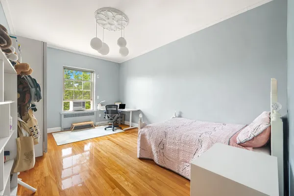 a bedroom with a bed couch and a window
