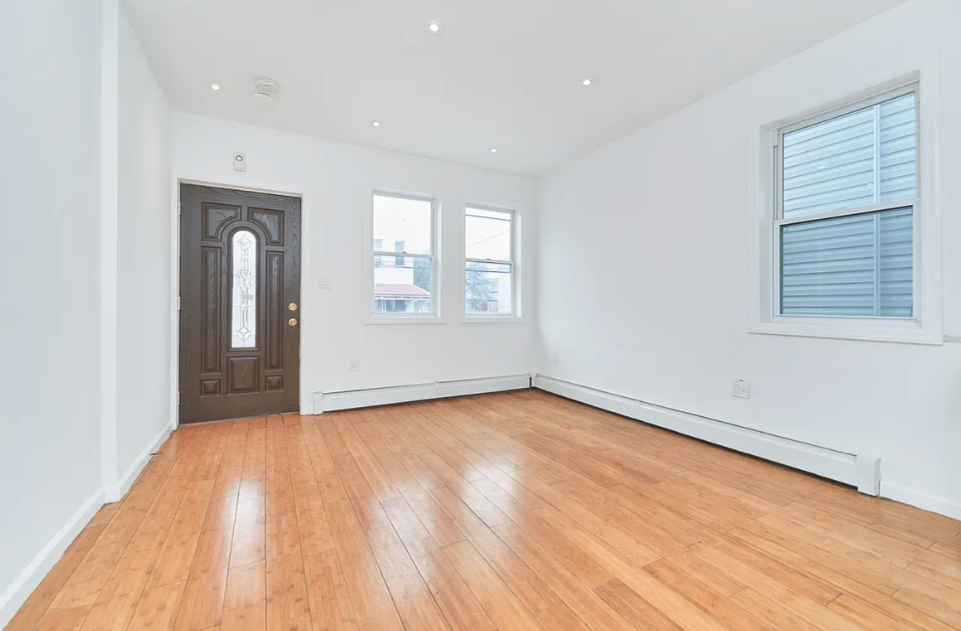 705 Schenck Avenue Brooklyn, NY 11207 - Photo 4 of 8 wooden floor in an empty room with a window