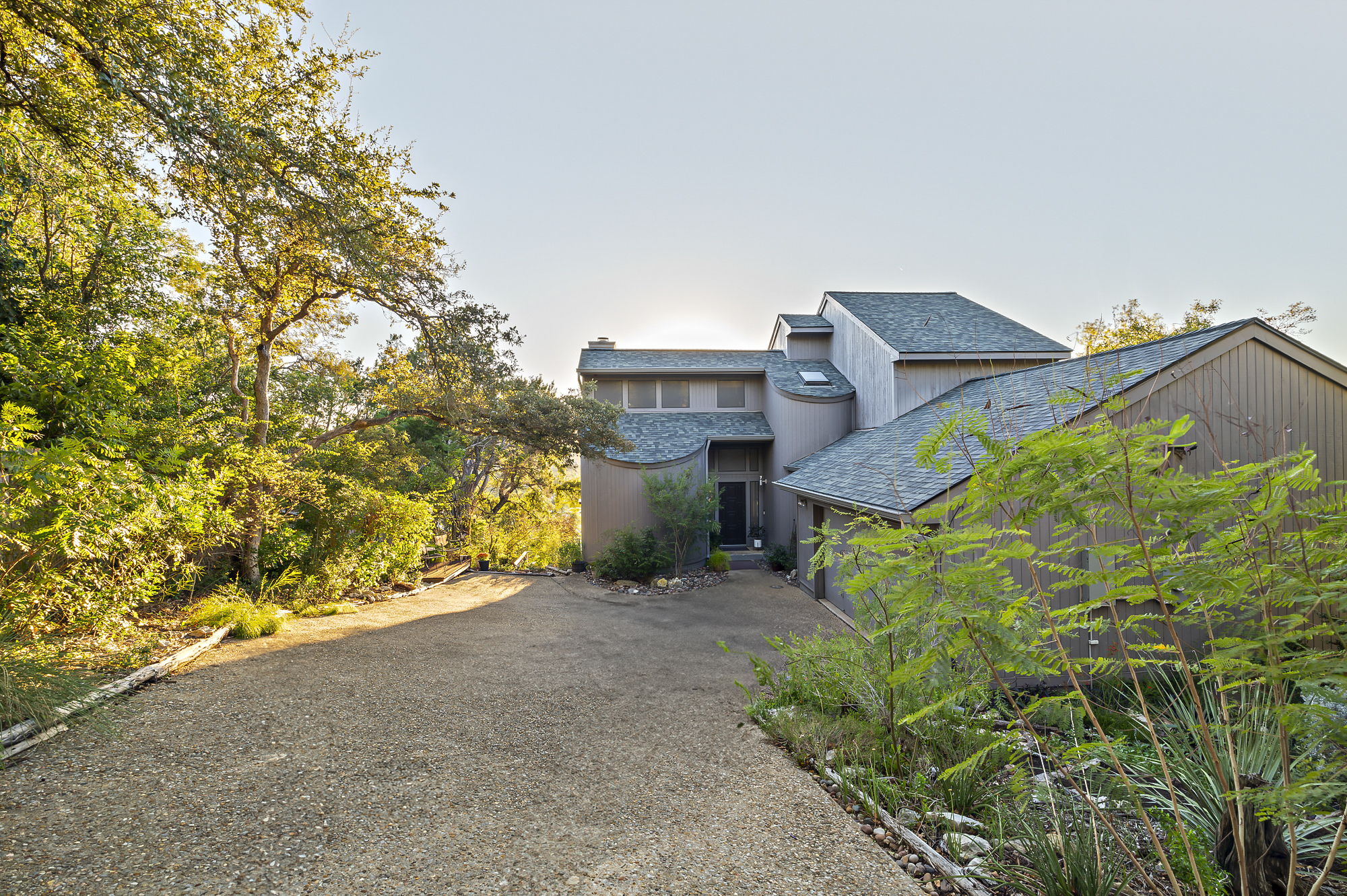 1605 The High Road Austin, TX 78746 - Photo 3 of 45 front view of a house with a yard