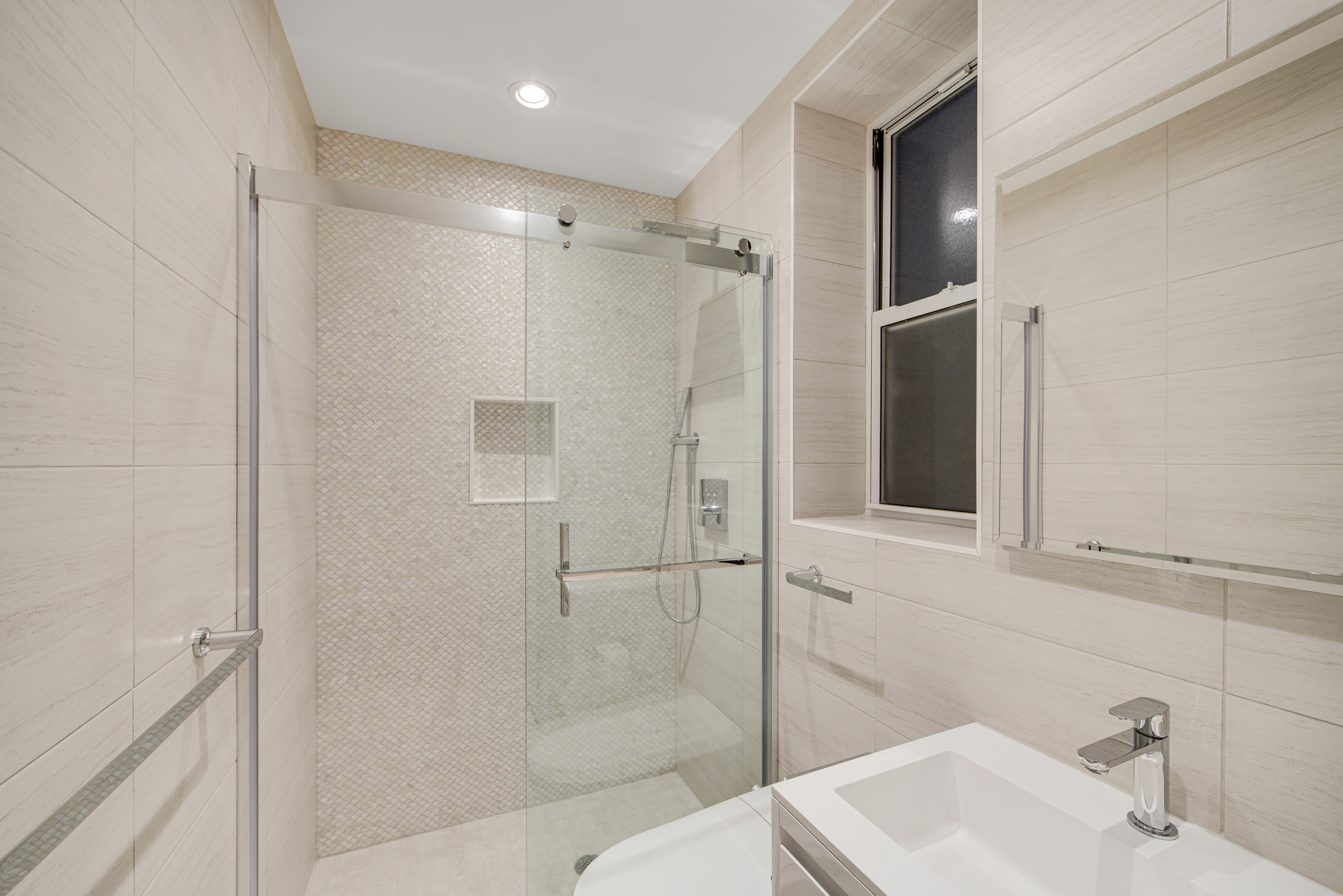 214 West 16th Street, Unit 1W Manhattan, NY 10011 - Photo 6 of 13 a bathroom with a sink toilet and shower