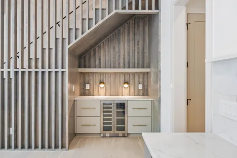 a view of cabinets and utility room with racks on the wall