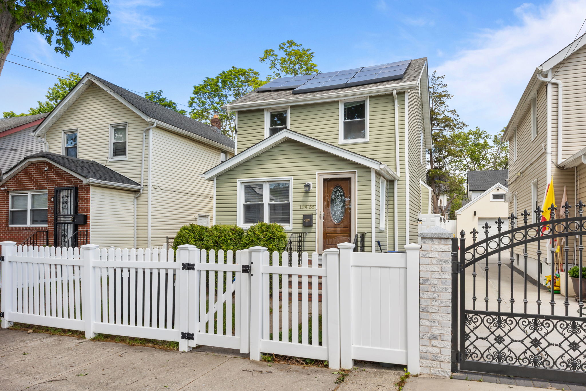 194-35 114th Drive Queens, NY 11412 - Photo 14 of 21 a front view of a house with wooden fence