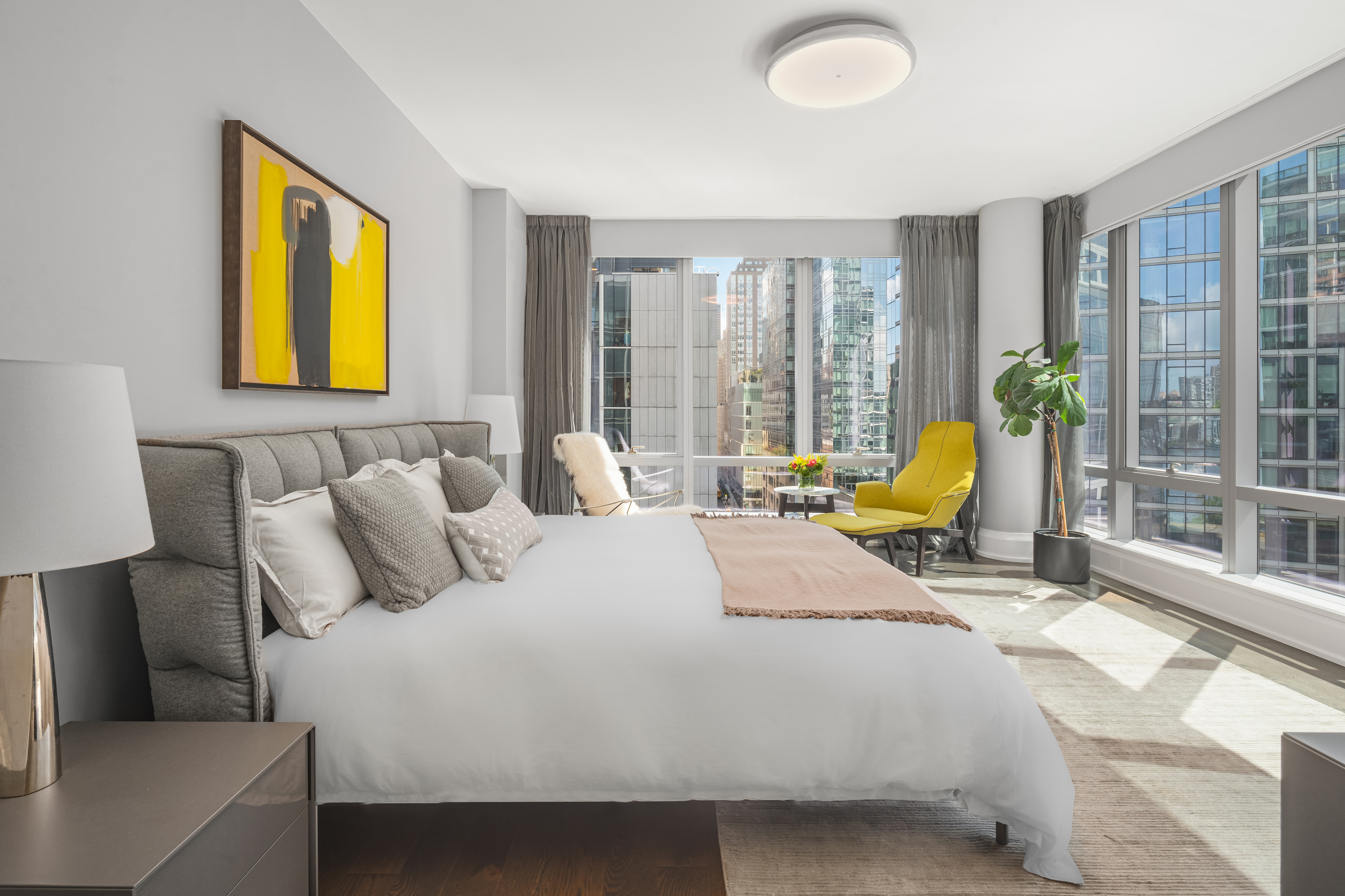 50 Riverside Boulevard, Unit 10P Manhattan, NY 10069 - Photo 8 of 21 a bedroom with a bed and a lamp next to a window