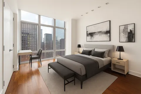 a spacious bedroom with a bed and a large window