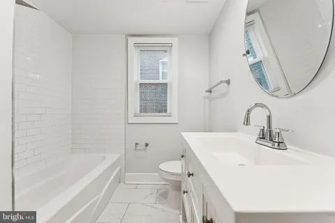 a bathroom with a sink a toilet and a bathtub