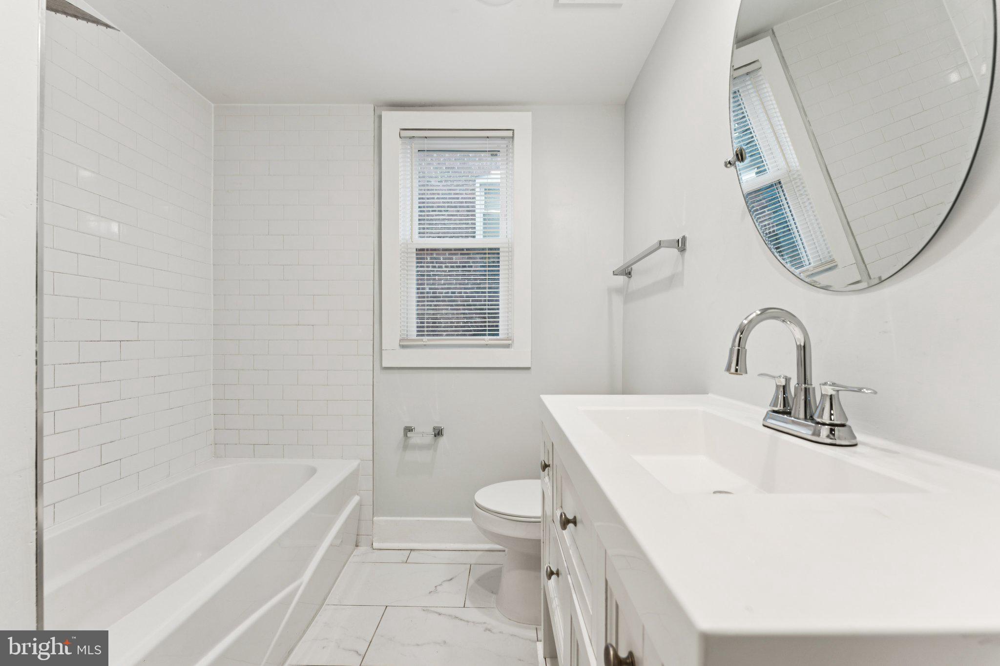 2822 28th Street Southeast Washington, DC 20020 - Photo 7 of 57 a bathroom with a sink a toilet and a bathtub