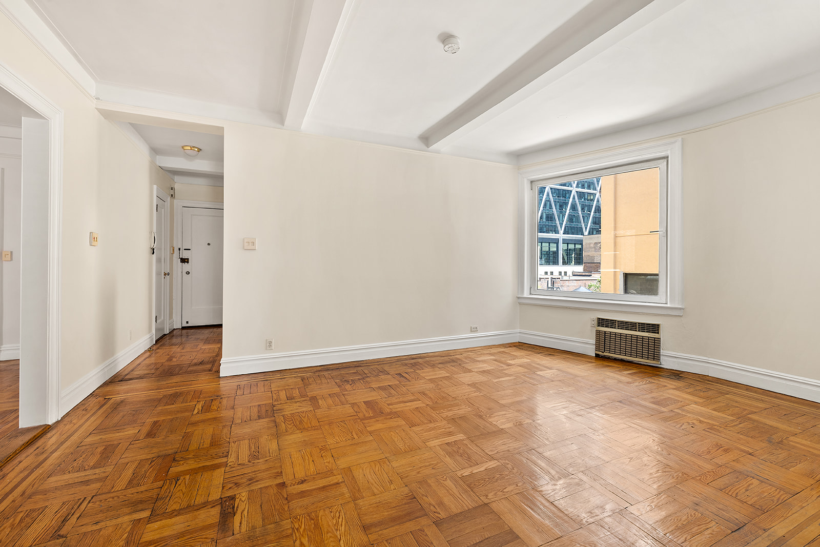 345 West 55th Street, Unit 8AB Manhattan, NY 10019 - Photo 7 of 14 a view of an empty room with wooden floor and a window